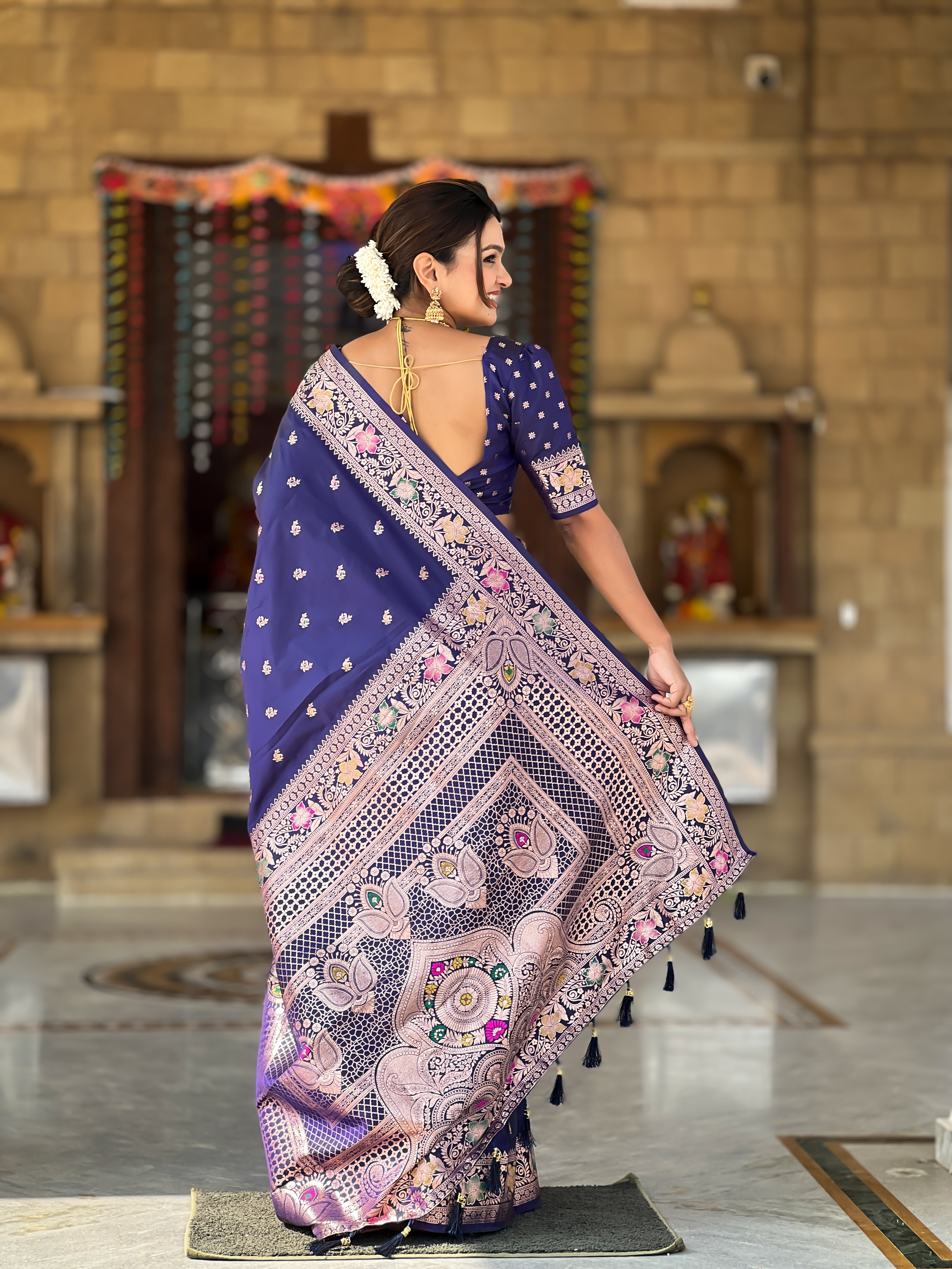 Grace yourself with the timeless beauty of this navy blue Banarasi silk saree