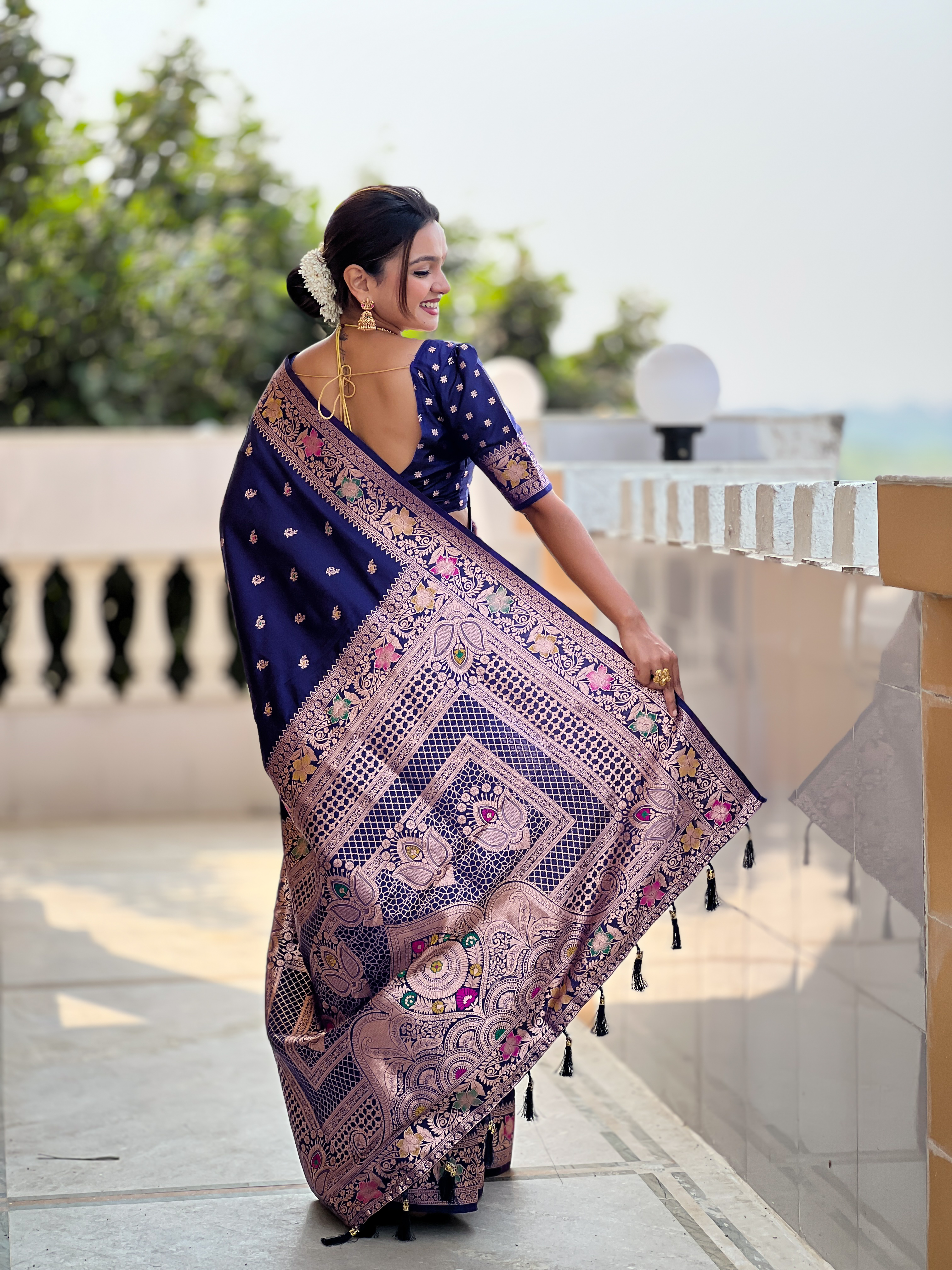 Grace yourself with the timeless beauty of this navy blue Banarasi silk saree