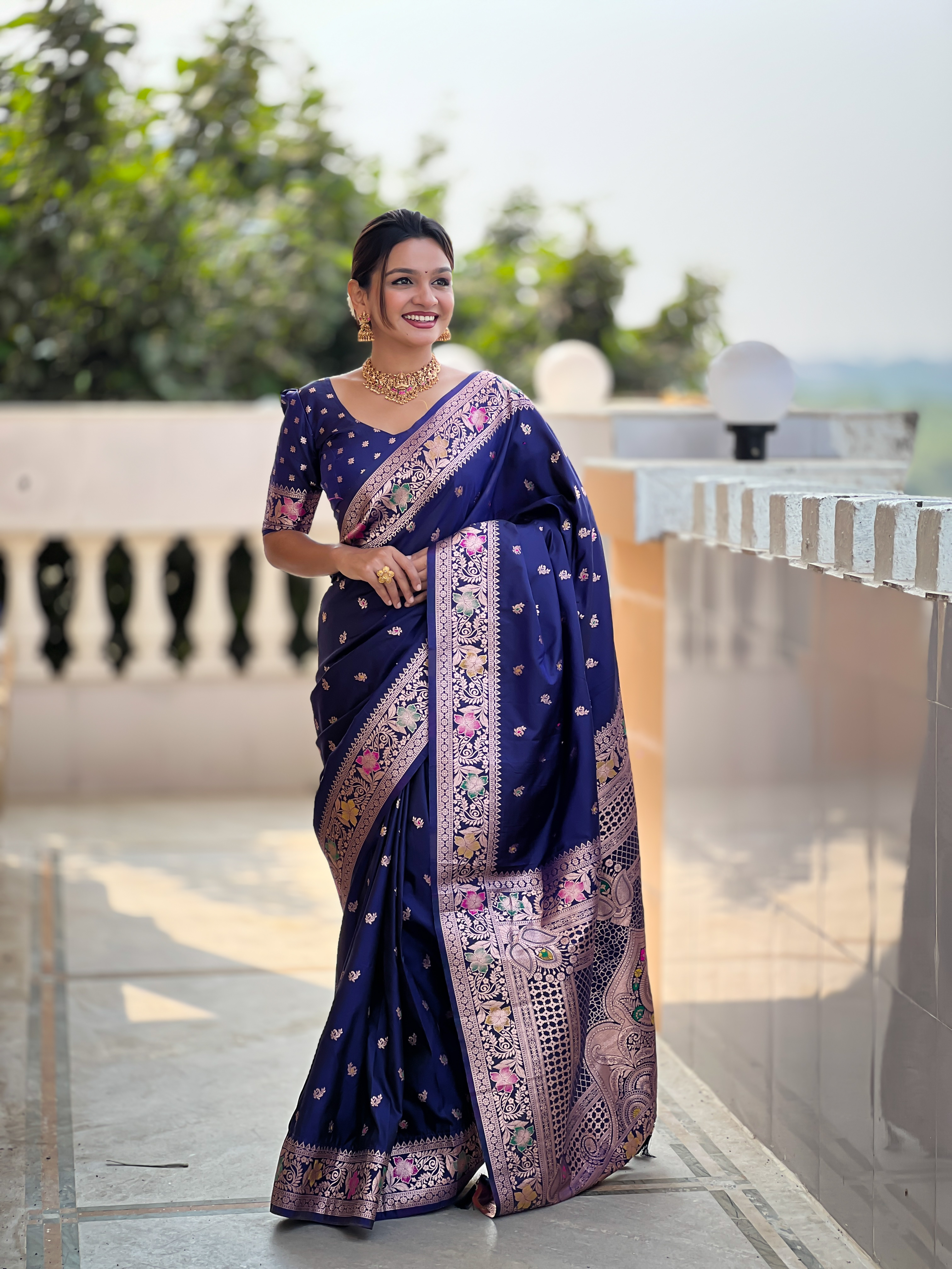 Grace yourself with the timeless beauty of this navy blue Banarasi silk saree