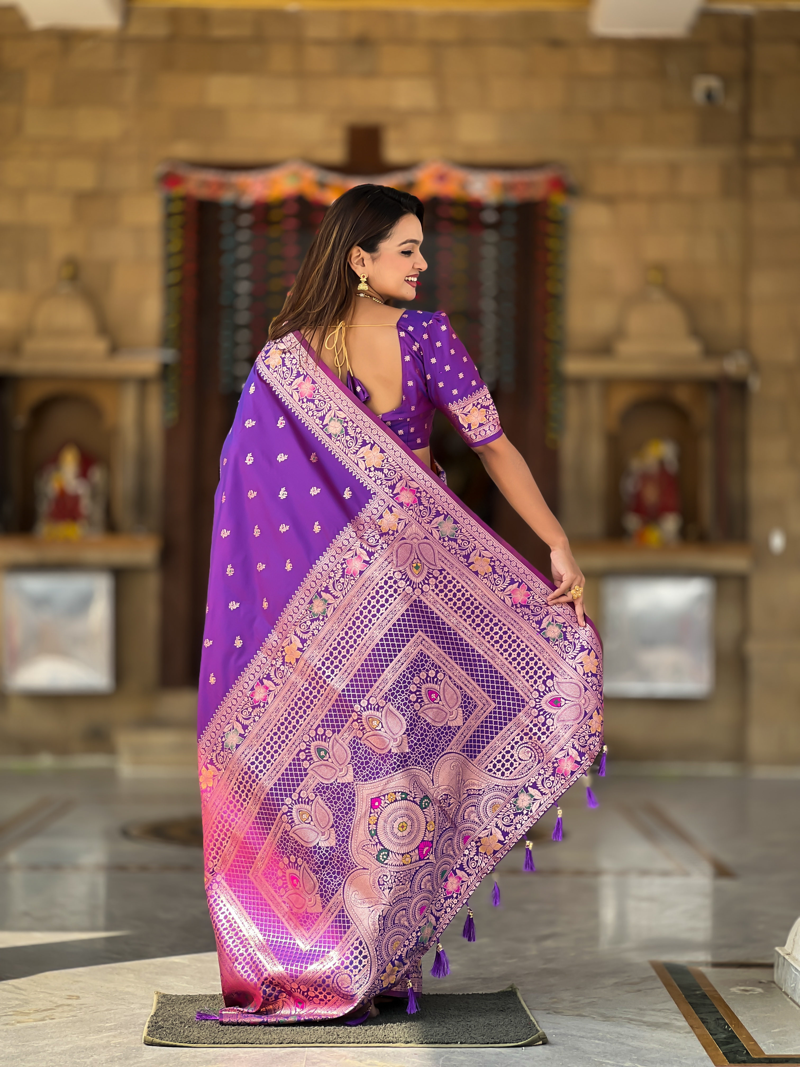 Enchant everyone with the regal charm of this violet Banarasi silk saree