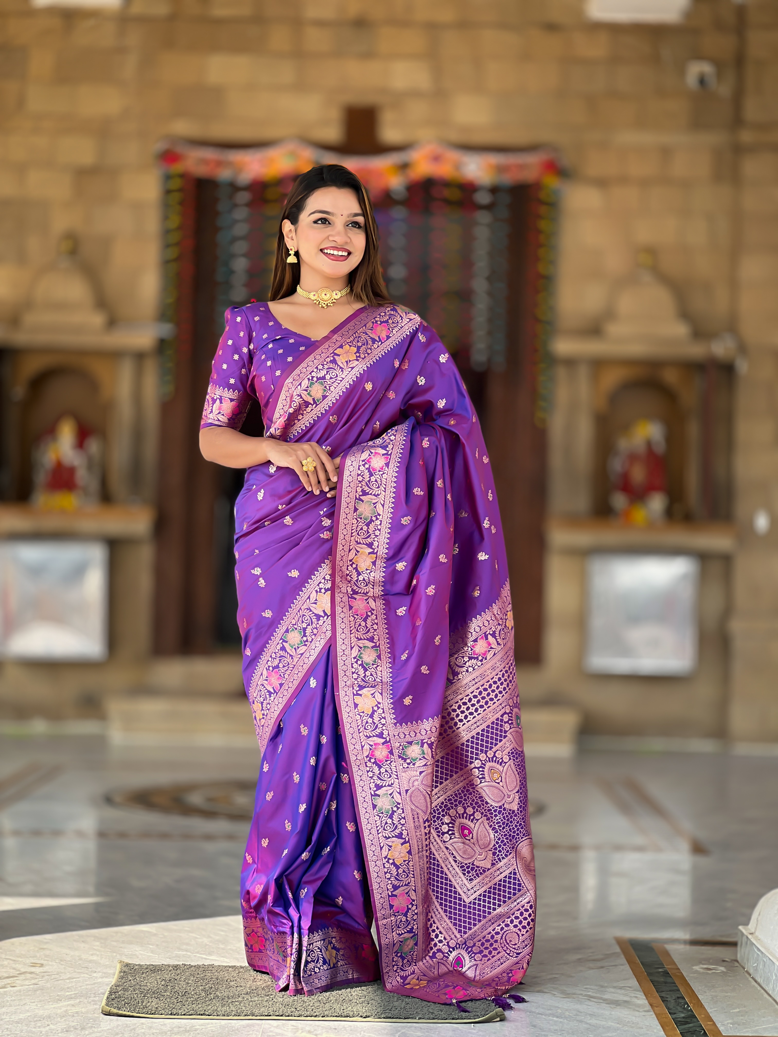 Enchant everyone with the regal charm of this violet Banarasi silk saree