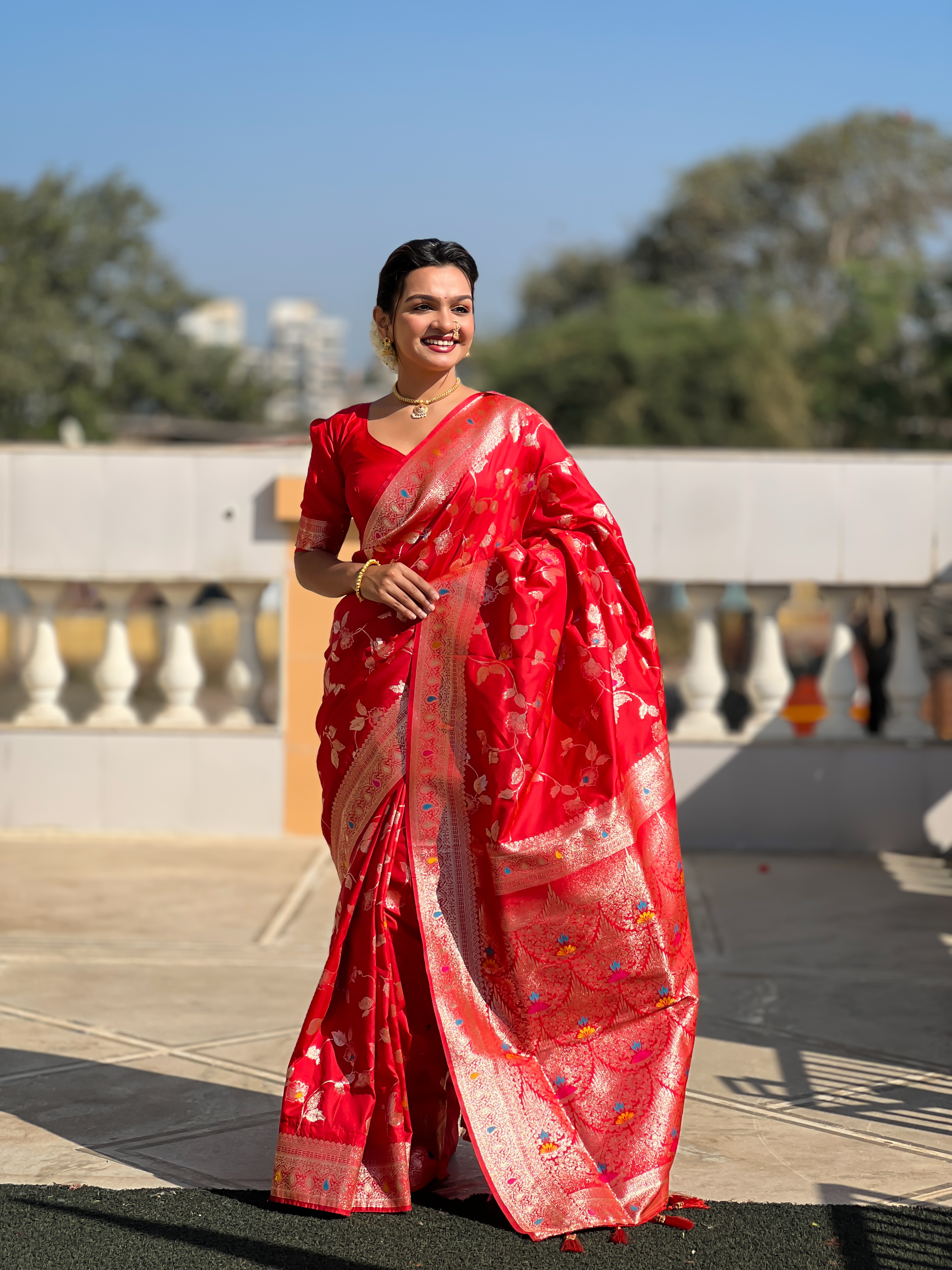 Make a bold and elegant statement with this striking red Banarasi silk saree