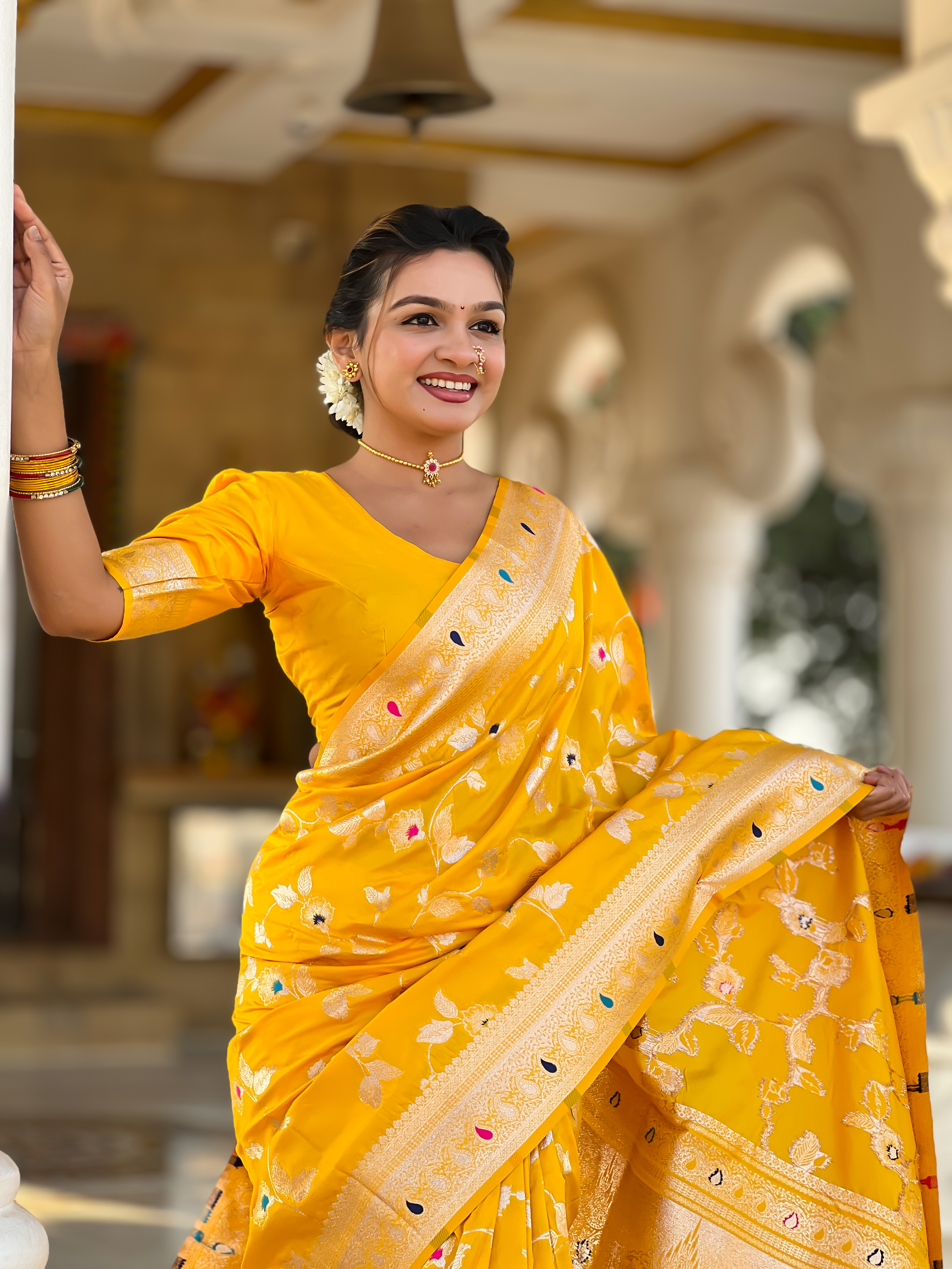 Illuminate every occasion with the radiant charm of this vibrant yellow Banarasi silk saree