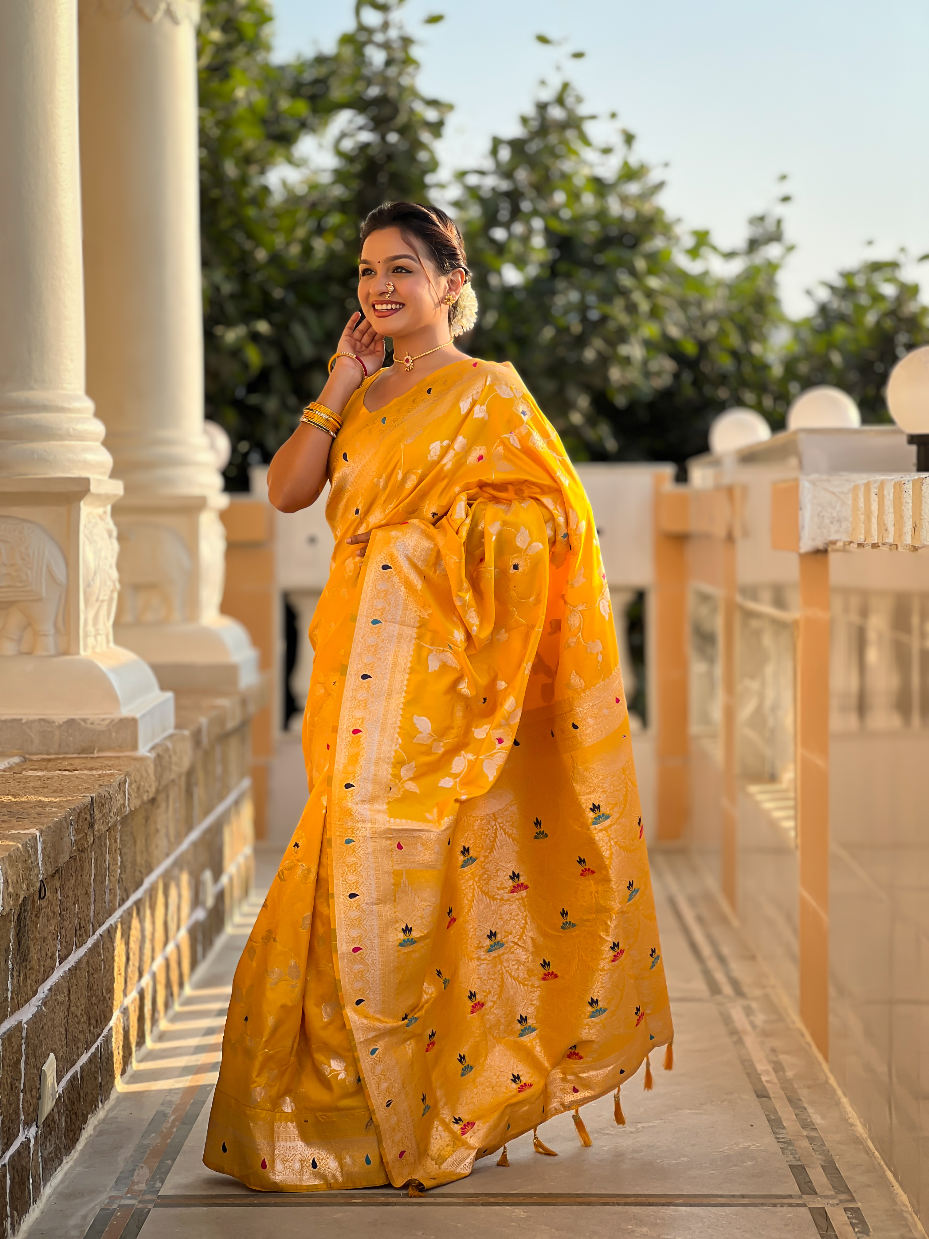 Illuminate every occasion with the radiant charm of this vibrant yellow Banarasi silk saree