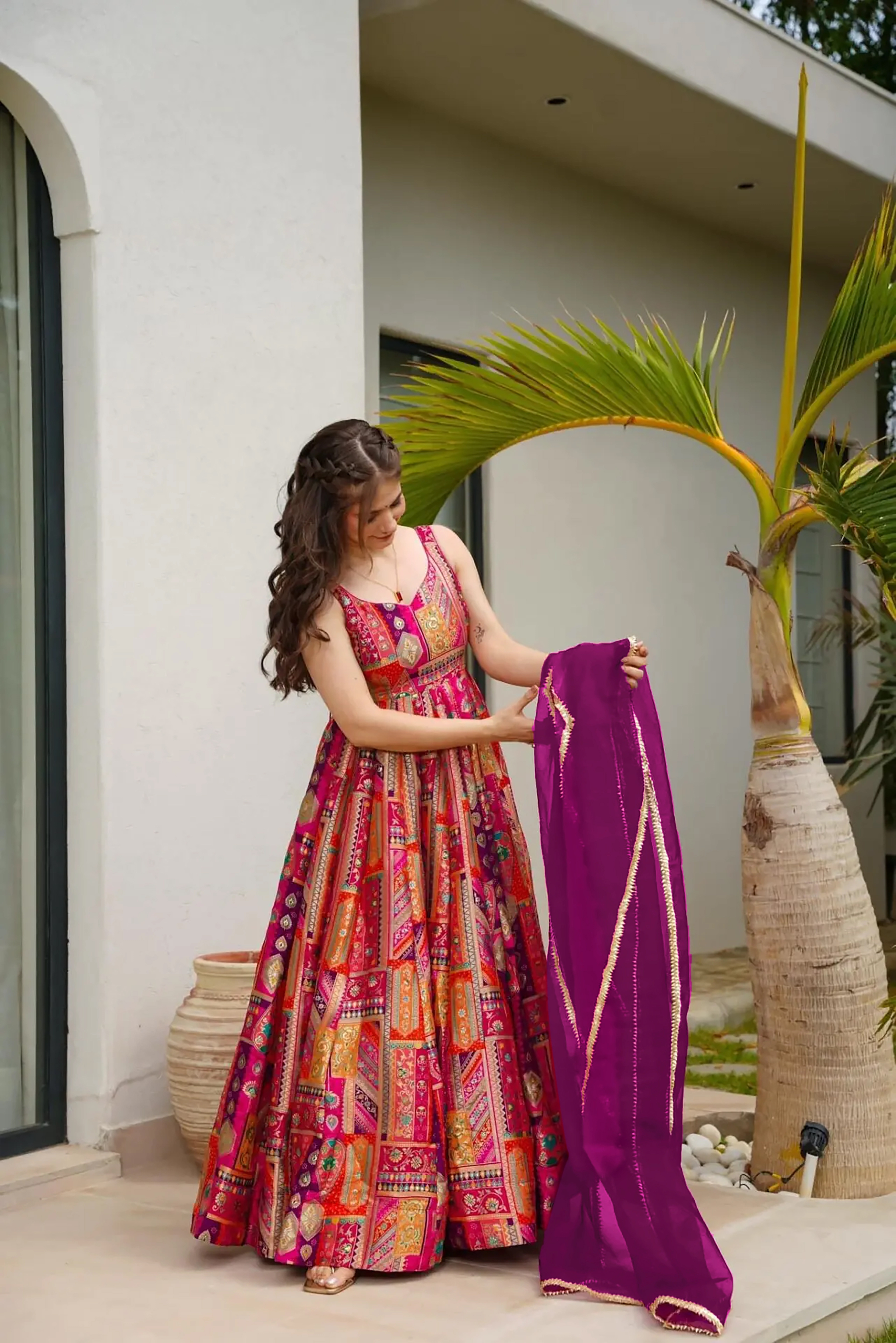 Make a bold statement with this vibrant pink readymade long gown