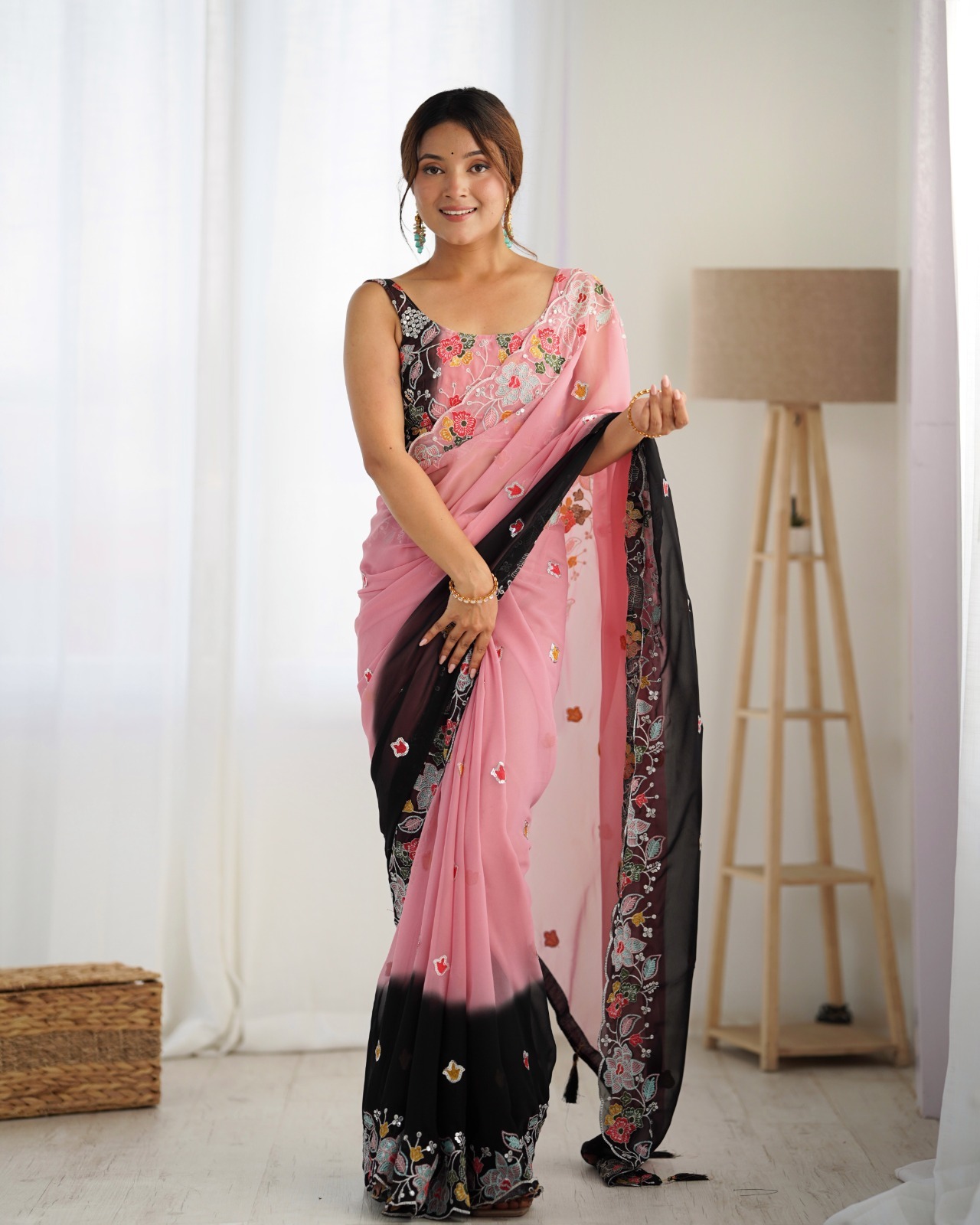 Make a bold and elegant statement with this exquisite black and pink saree