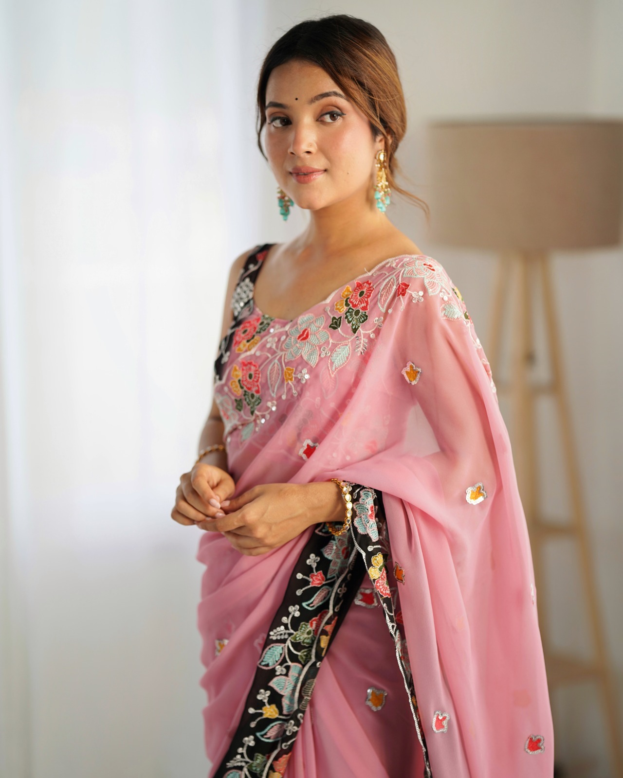 Make a bold and elegant statement with this exquisite black and pink saree