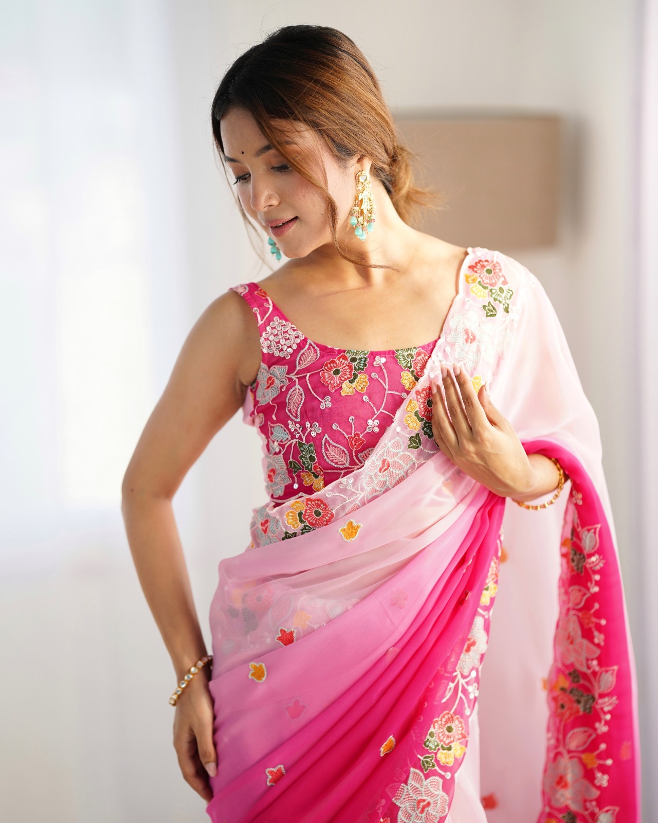 Drape yourself in the beauty of this stunning pink georgette saree