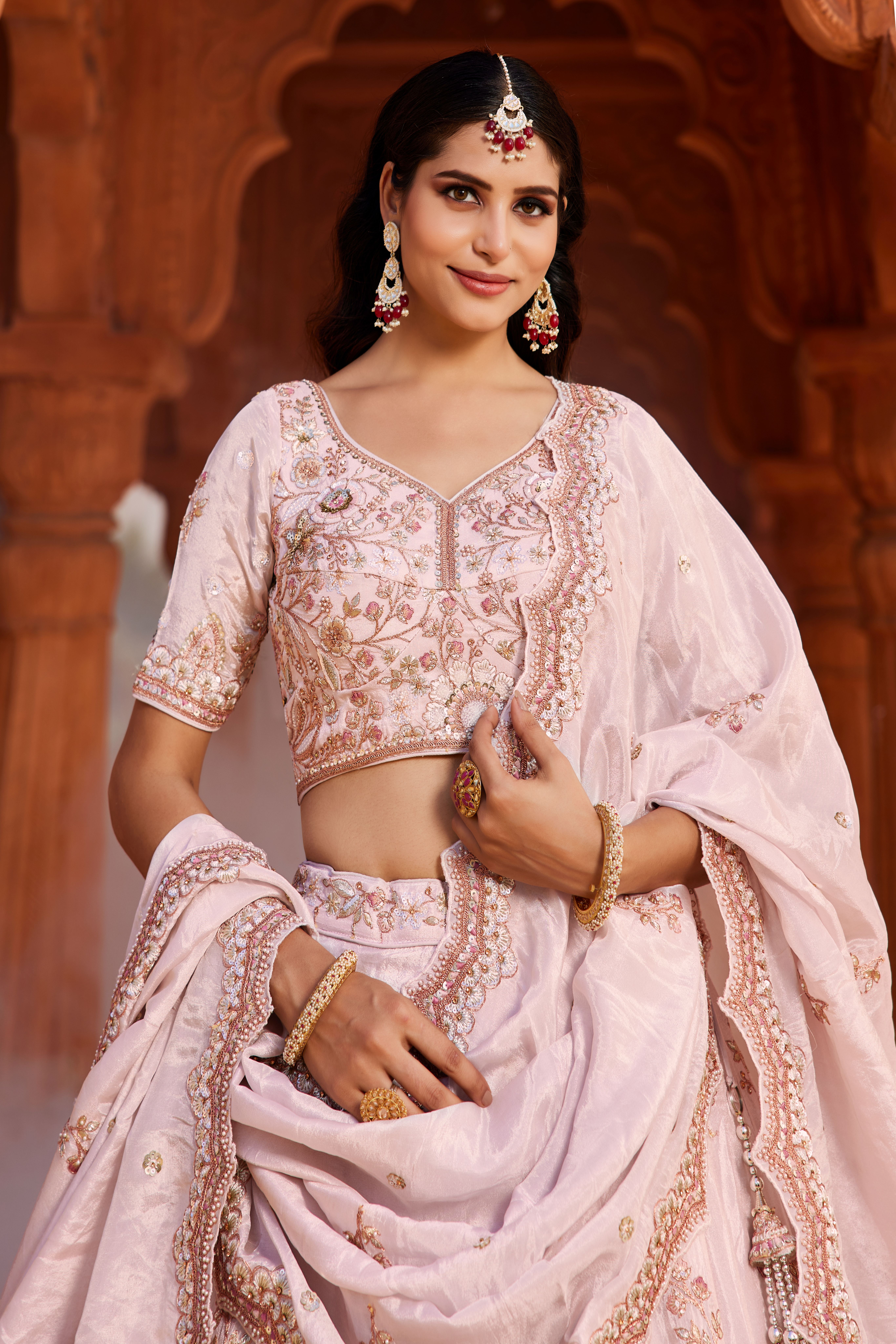 Make a captivating entrance with this stunning Coral Designer Lehenga
