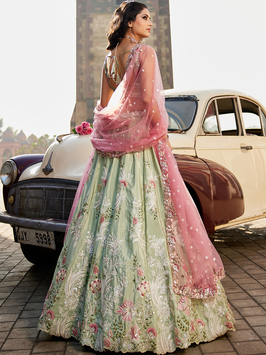 Step into the spotlight with this luxurious pistachio green satin lehenga