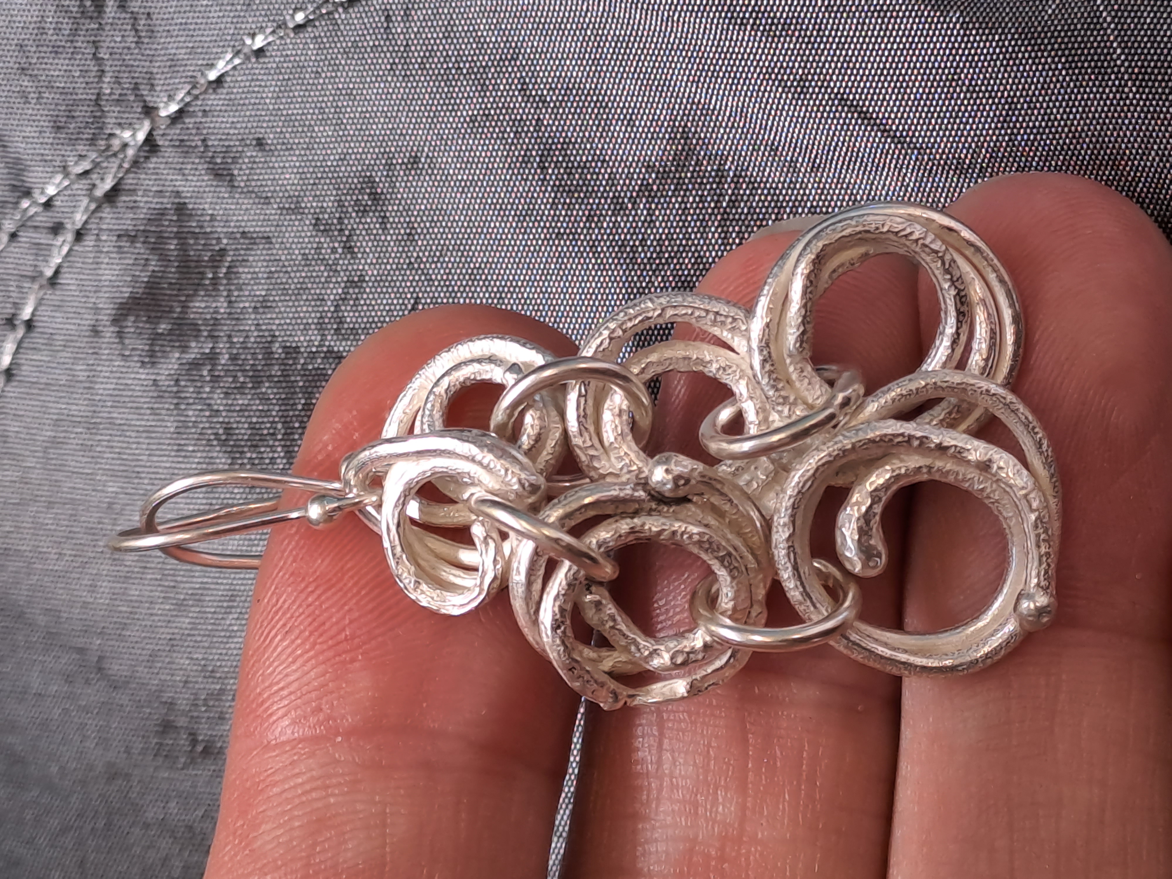 Silver Spiral Dangle Earrings with a molten and reticulated texture