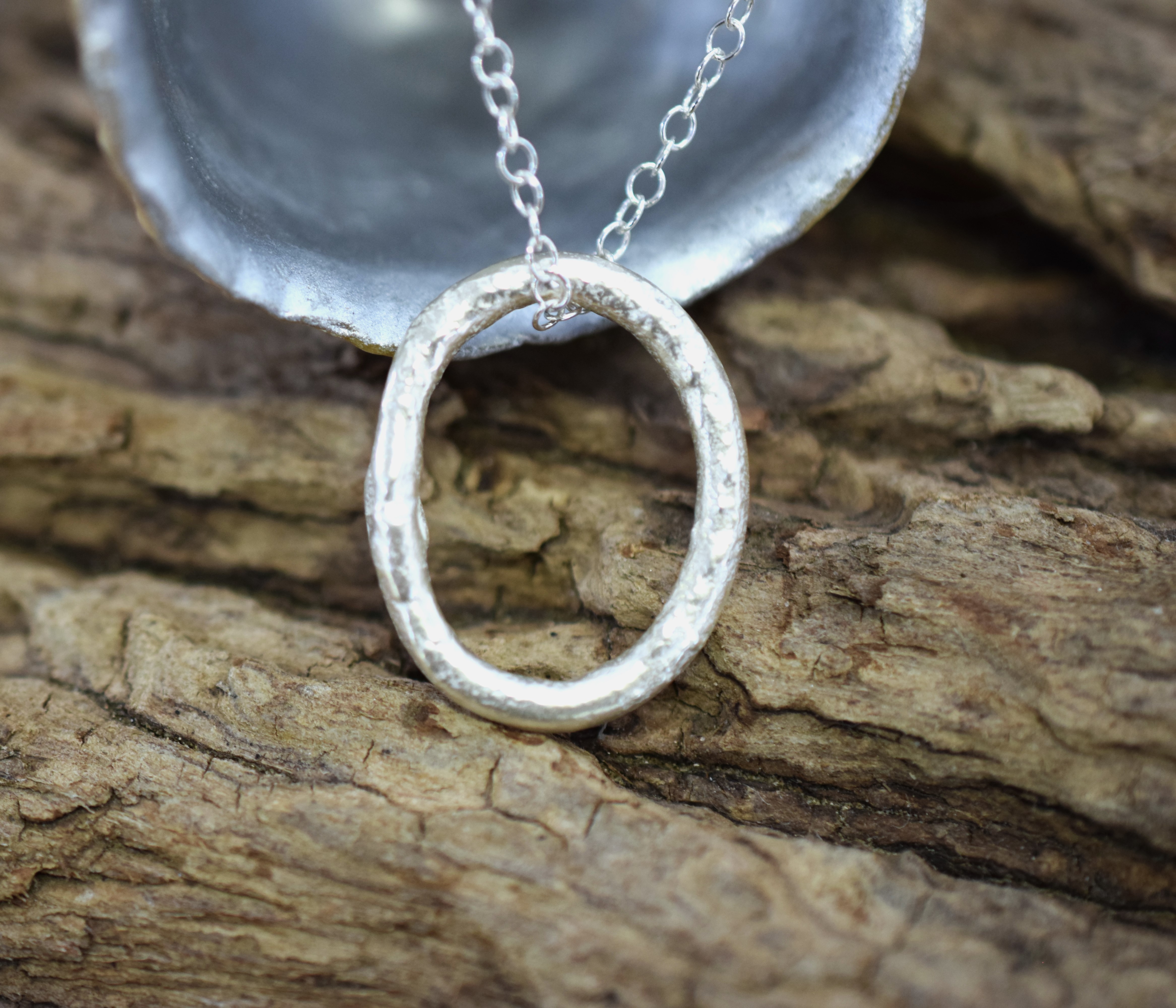 Molten Silver Oval Pendant with a Molten Texture