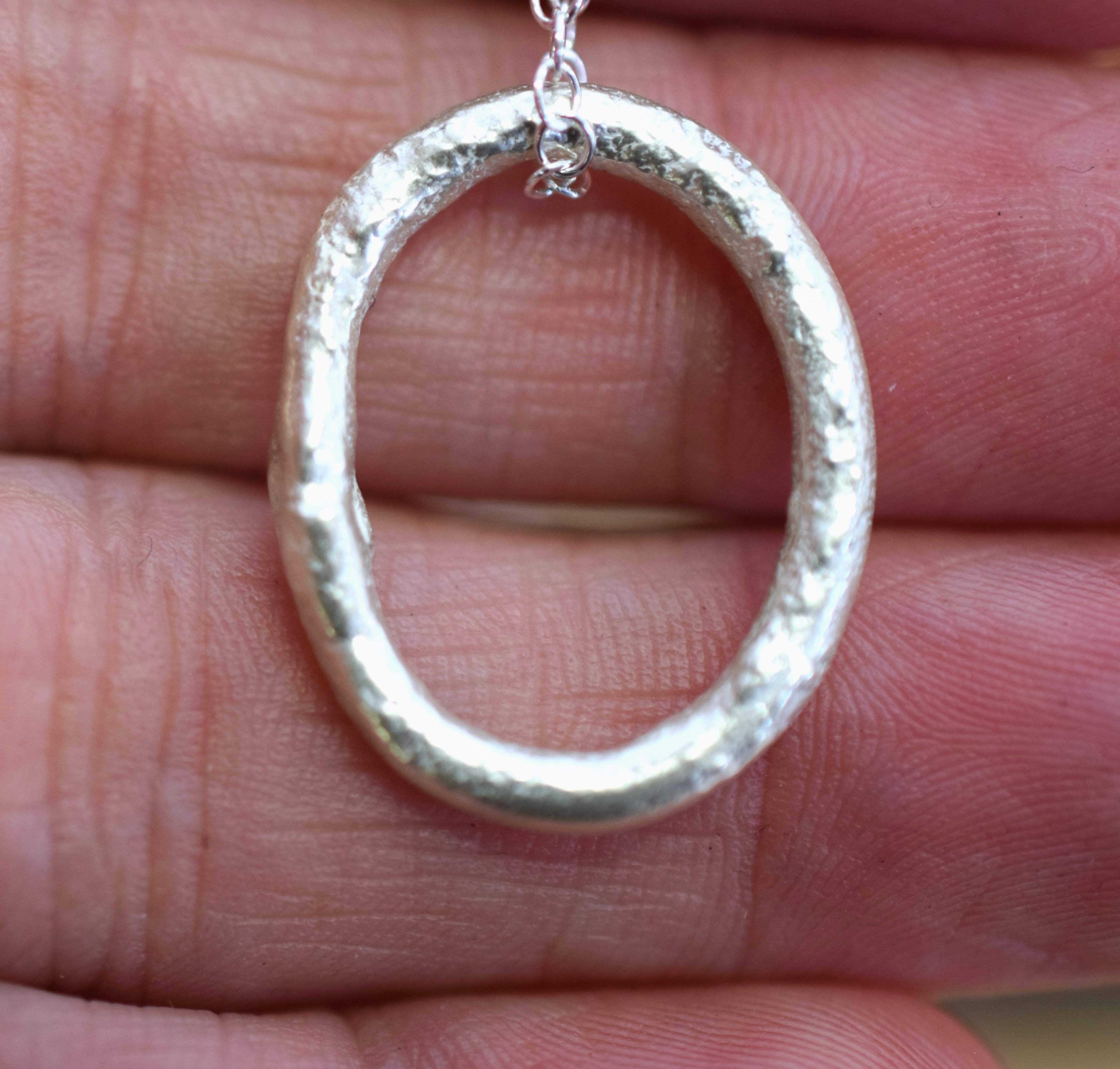 Molten Silver Oval Pendant with a Molten Texture