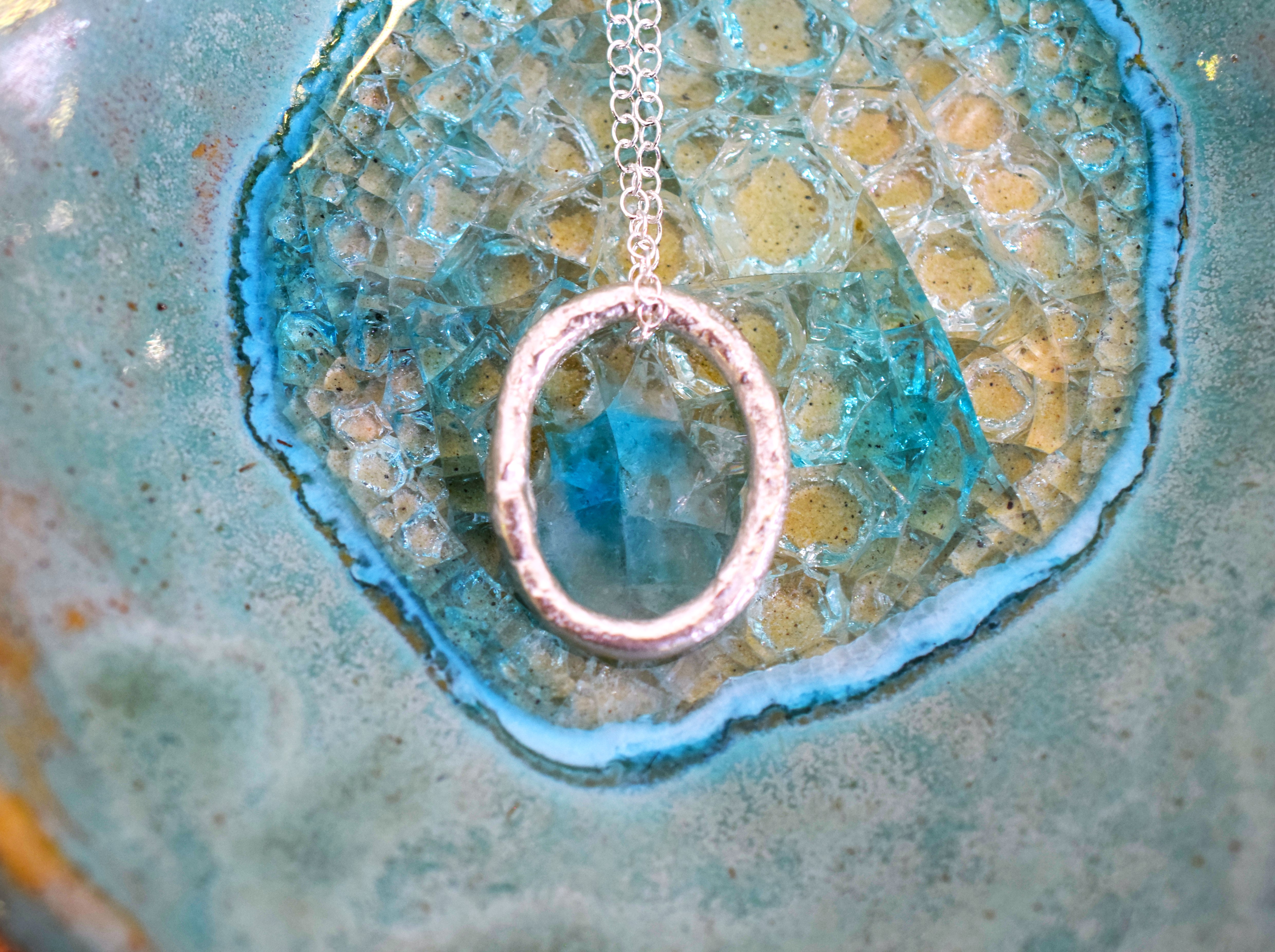 Molten Silver Oval Pendant with a Molten Texture