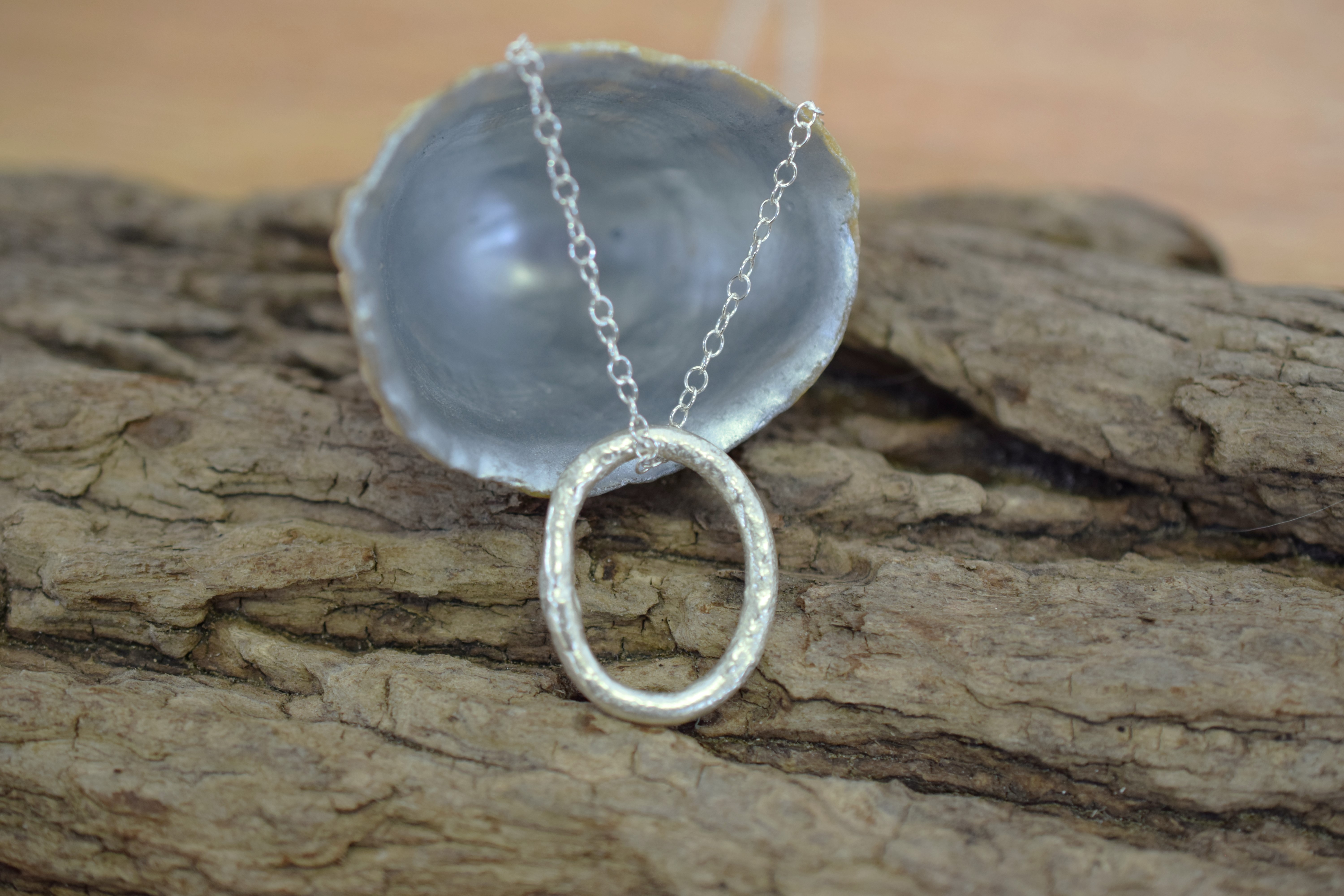 Molten Silver Oval Pendant with a Molten Texture