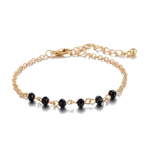 Bracelet doré avec perles noires