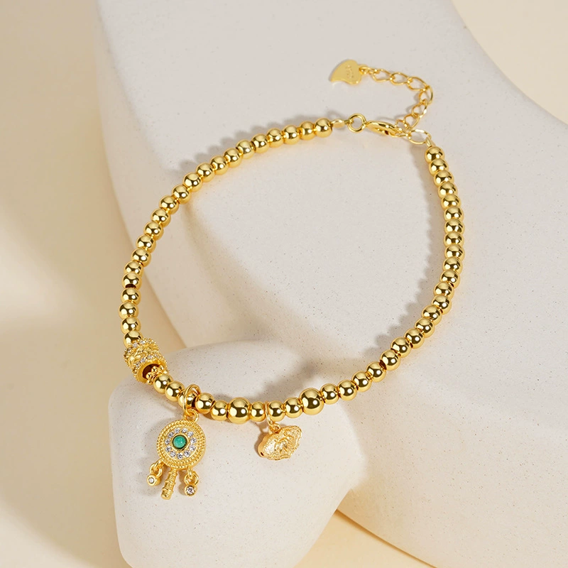 Tikia – Golden Rattle Charm Bead Bracelet