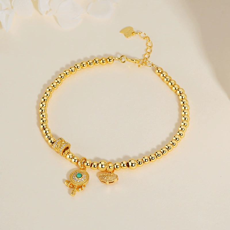 Tikia – Golden Rattle Charm Bead Bracelet