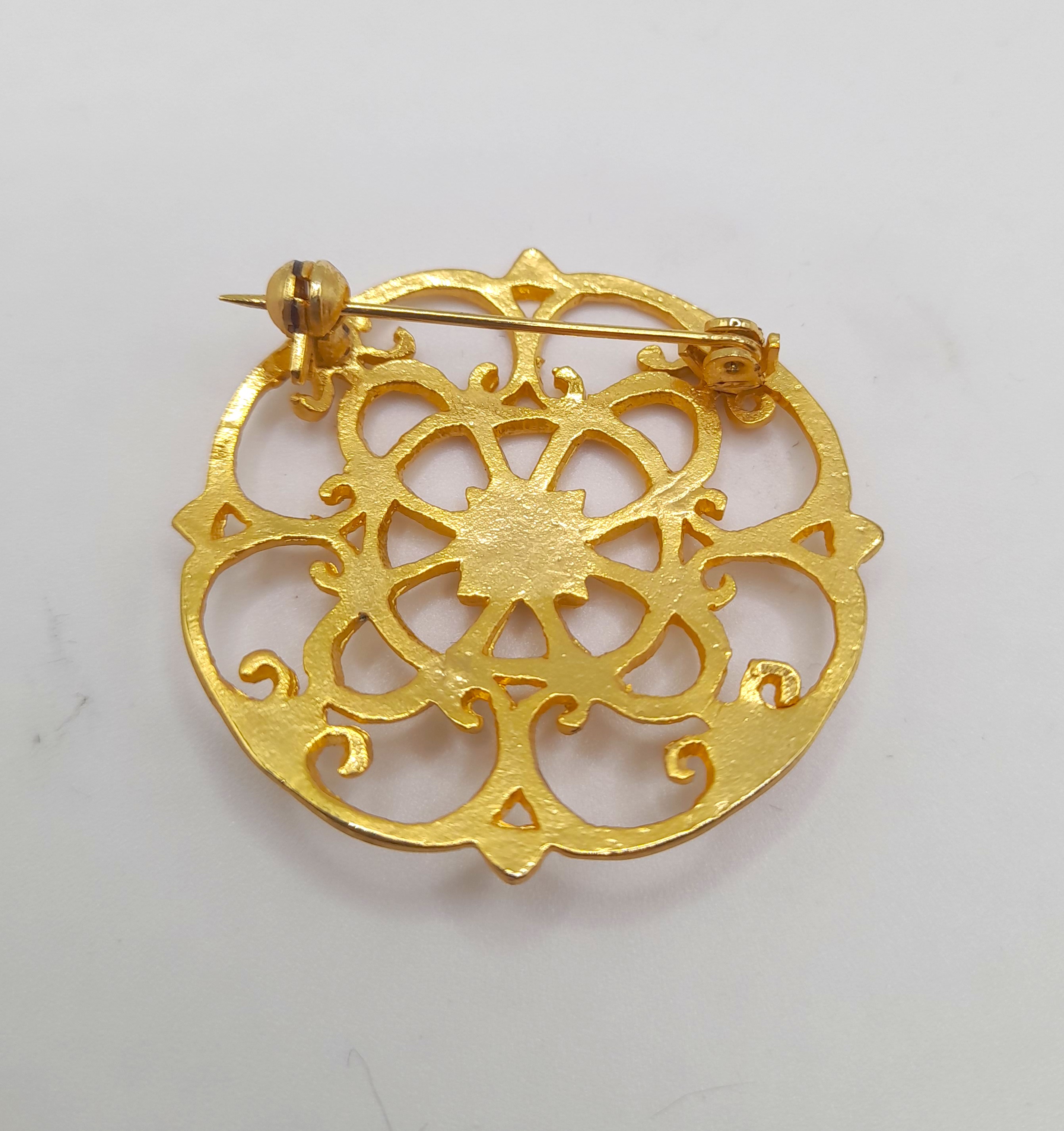 Vintage ornate gold tone brooch with trombone clasp