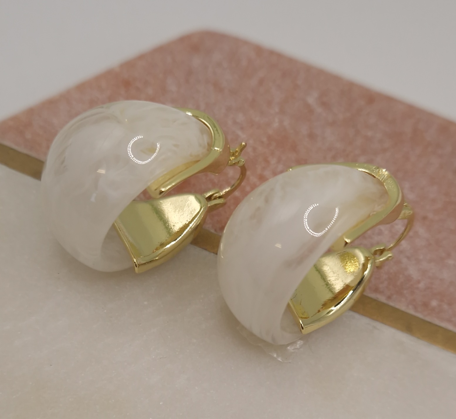 Earrings with an organic-shaped milky white stone