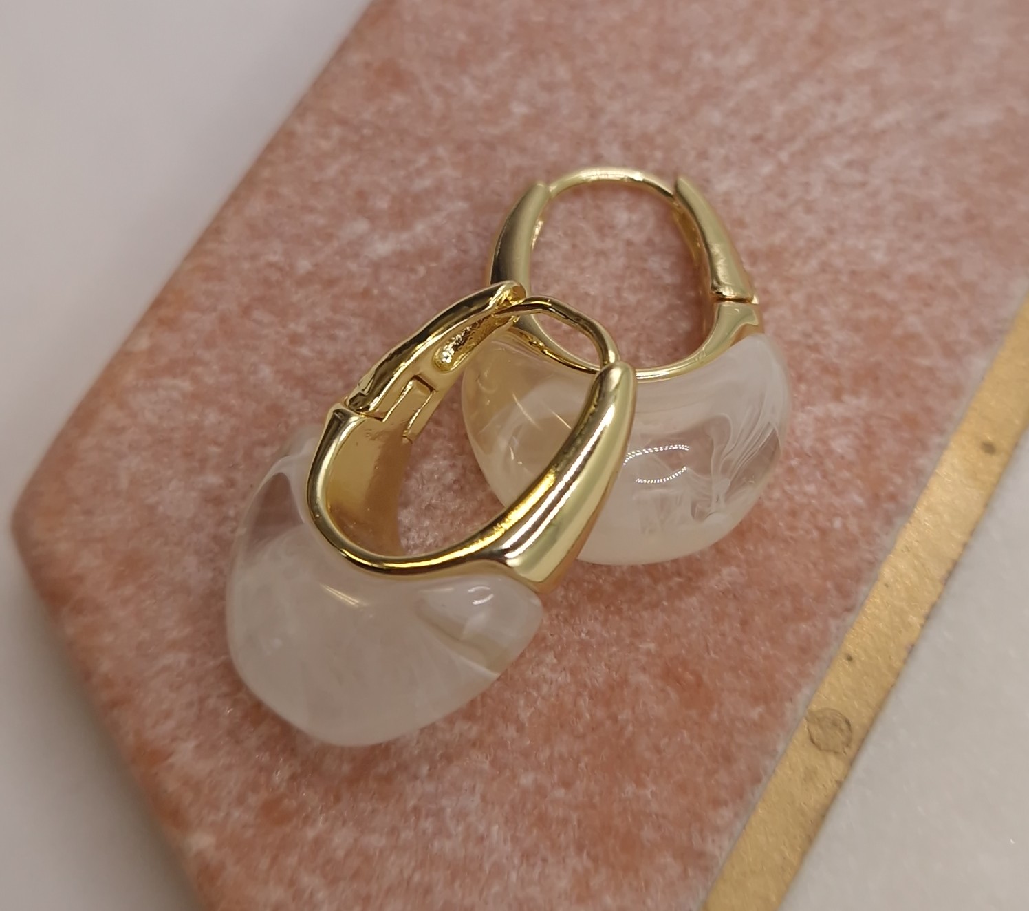 Huggie hoops with a milky white resin