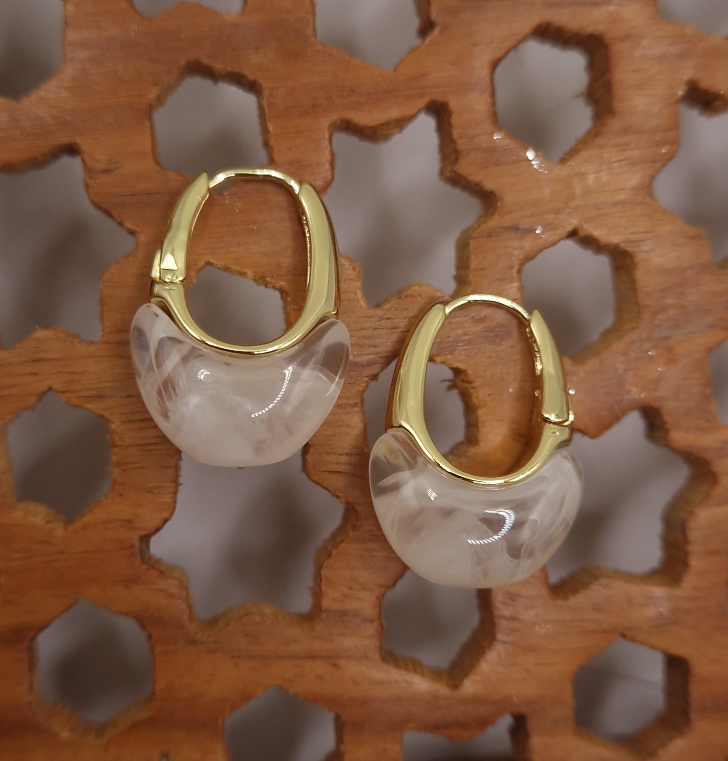 Huggie hoops with a milky white resin