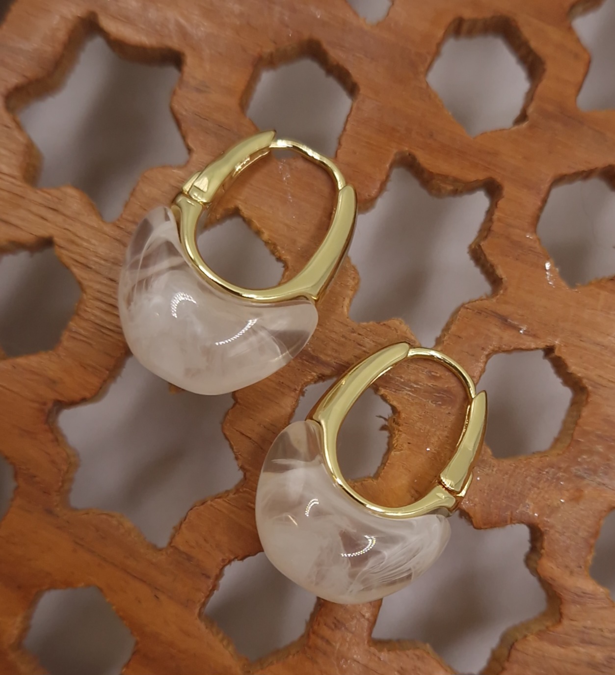 Huggie hoops with a milky white resin