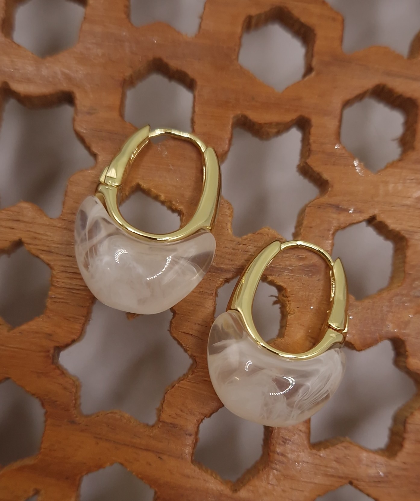 Huggie hoops with a milky white resin