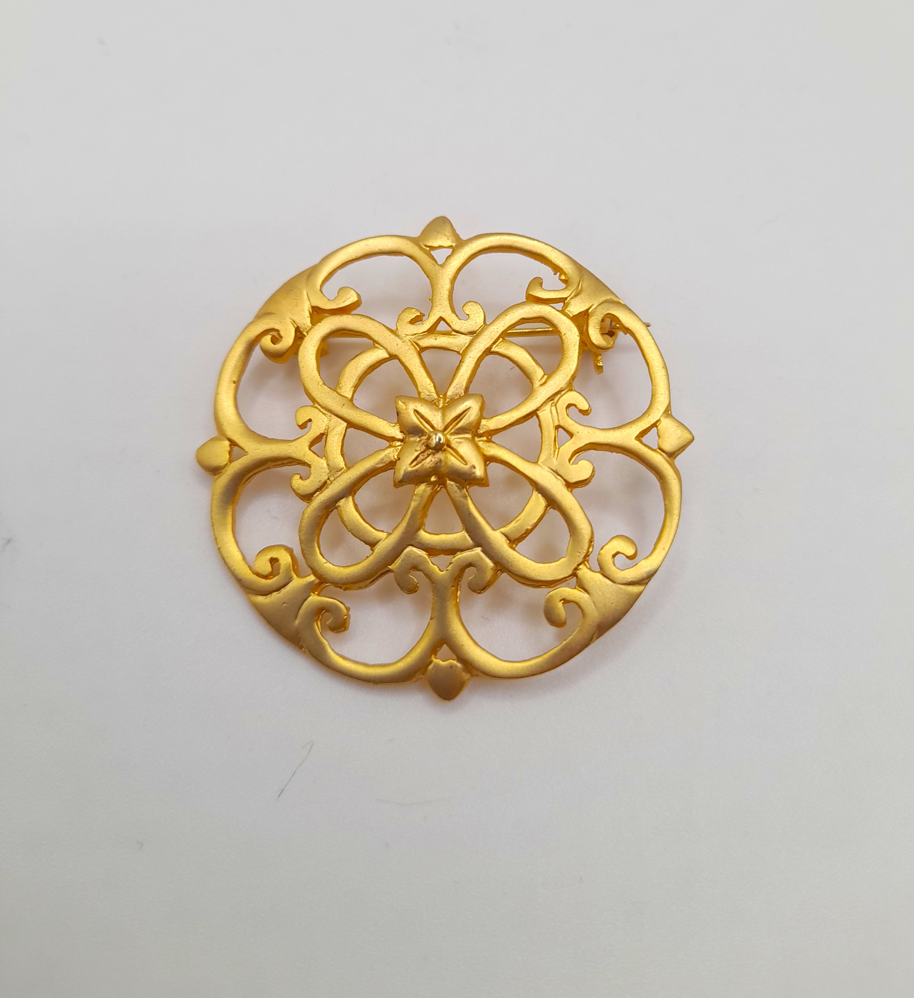 Vintage ornate gold tone brooch with trombone clasp