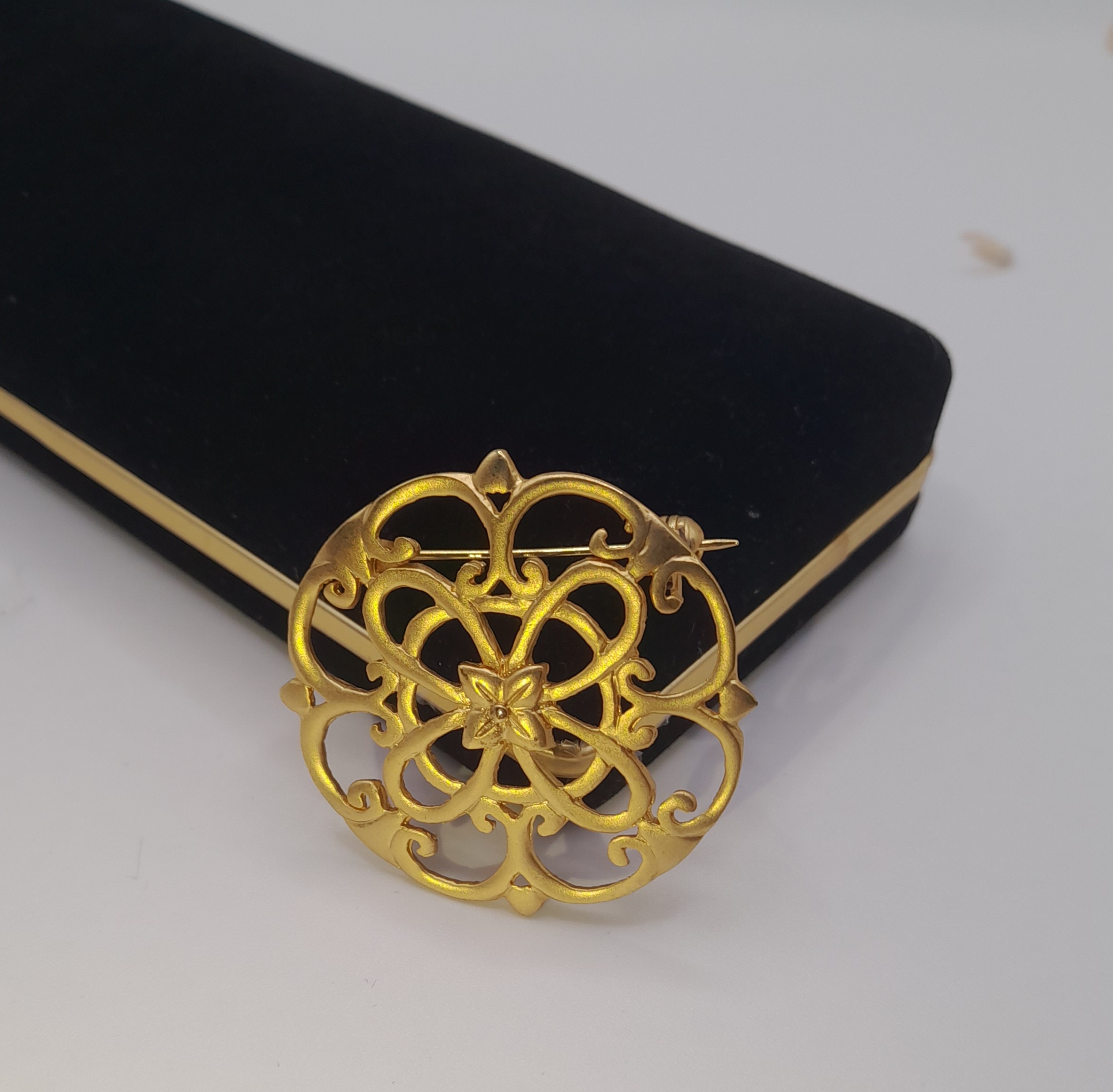 Vintage ornate gold tone brooch with trombone clasp