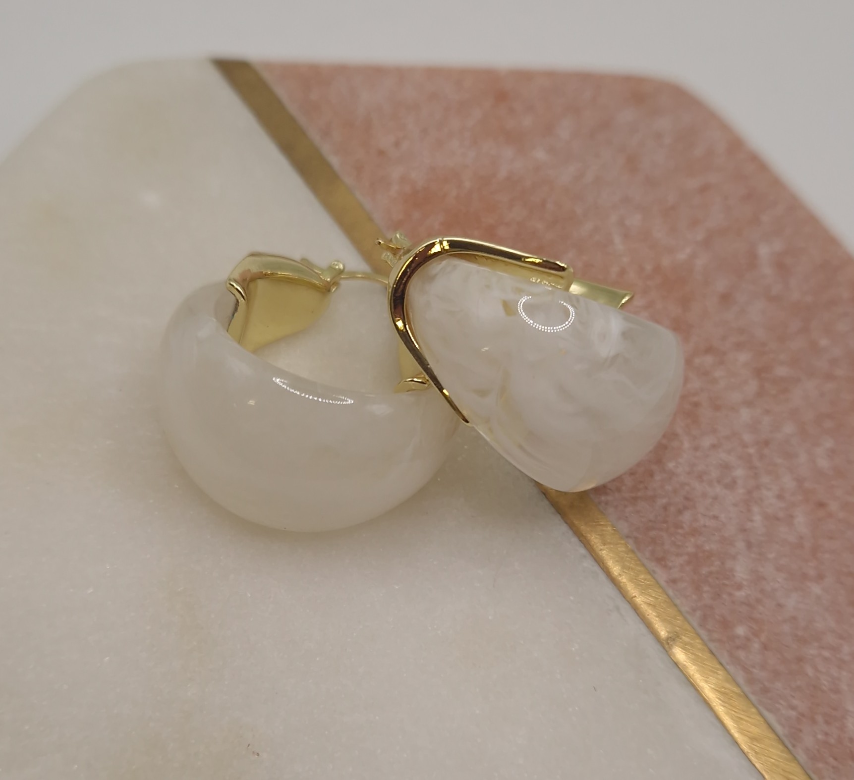 Earrings with an organic-shaped milky white stone