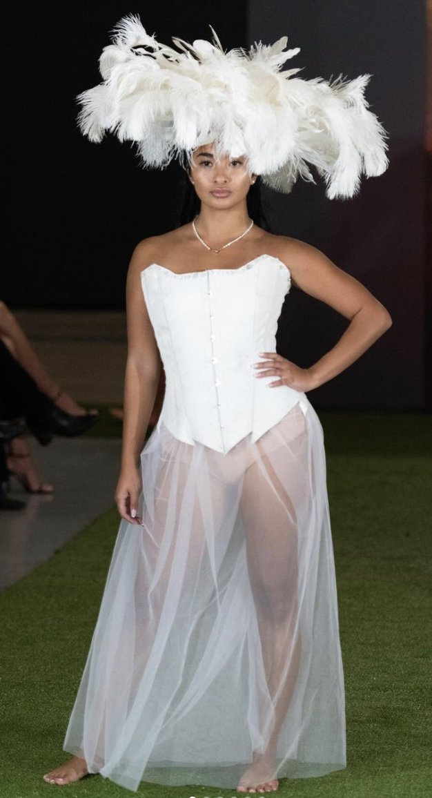 Elegant Feather Hat with Corset and Sheer Skirt