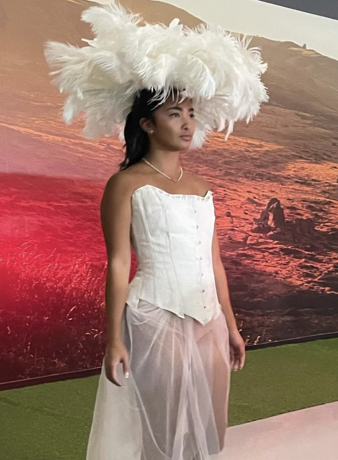 Elegant Feather Hat with Corset and Sheer Skirt
