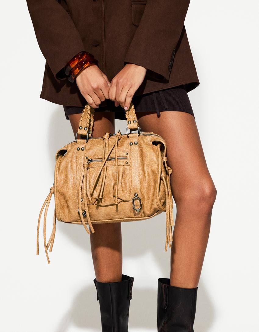 Worn-effect bowling bag with straps