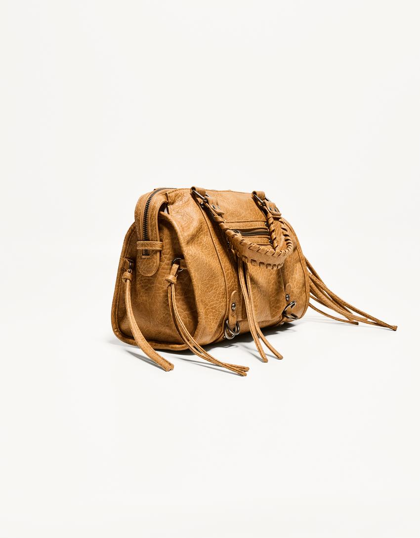 Worn-effect bowling bag with straps