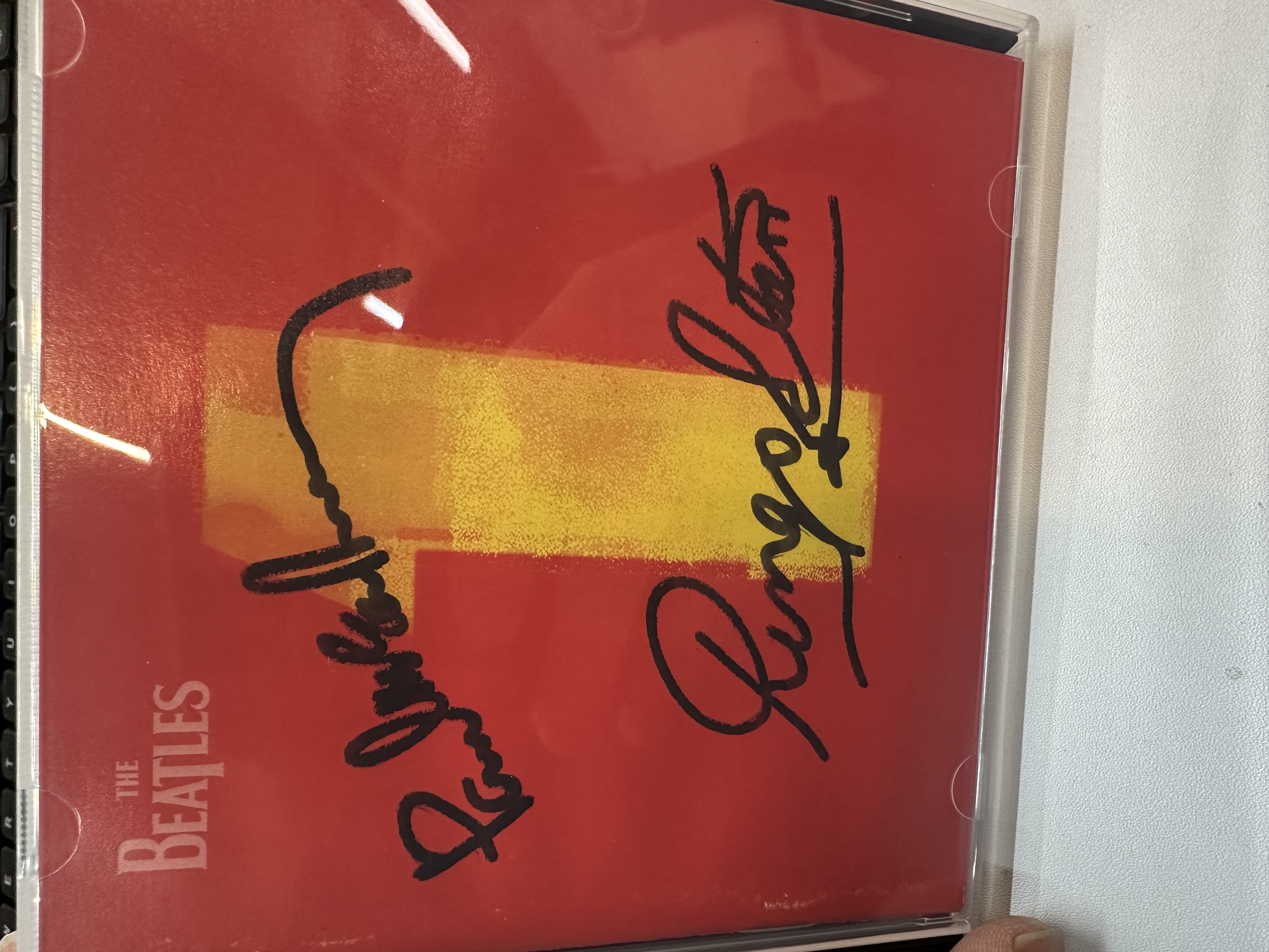 A1202 The Beatles 1 album signed by Ringo Starr and Paul McCartney