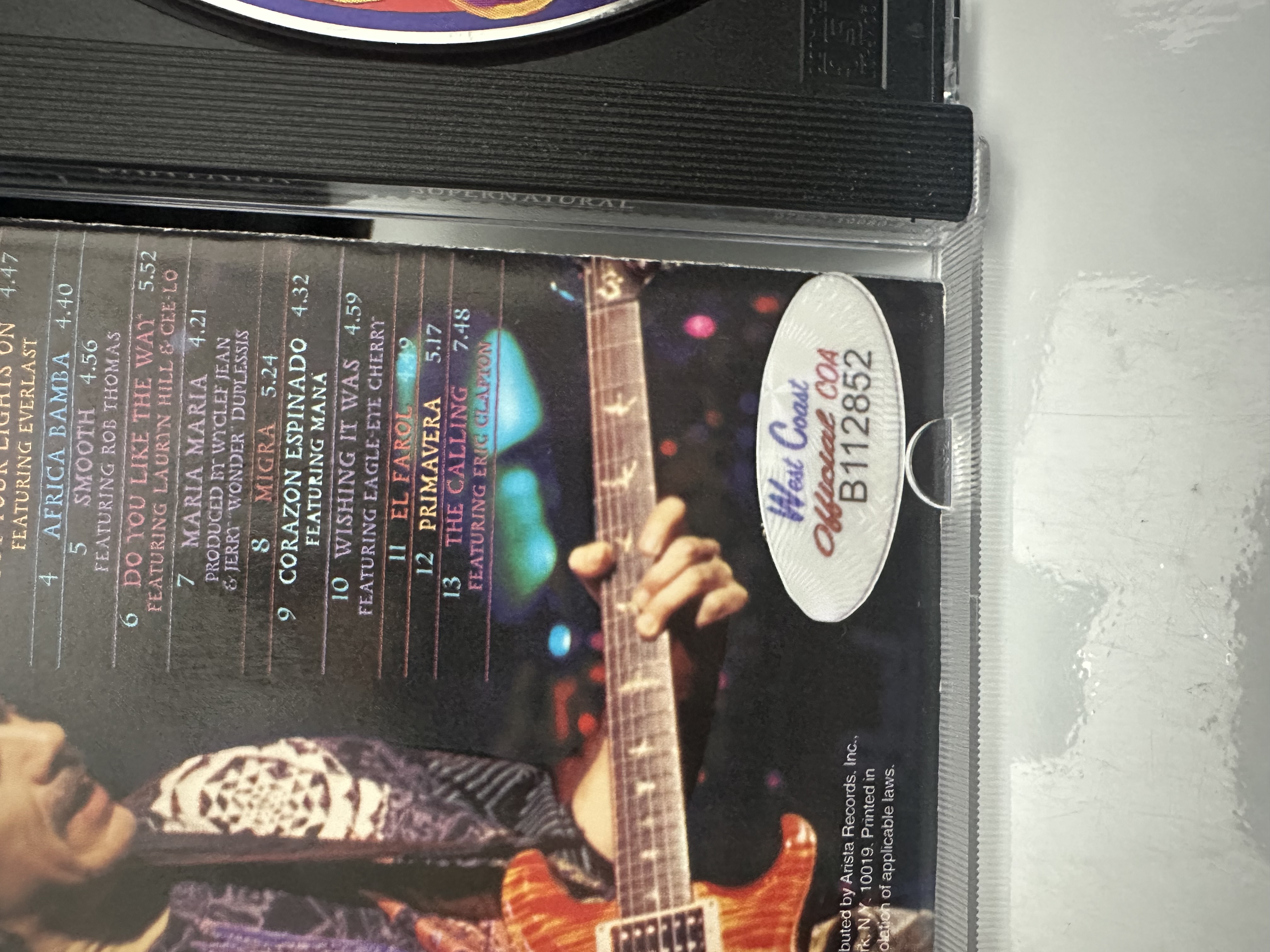 B112852 Santana supernatural signed autograph CD booklet signed by Carlos Santana