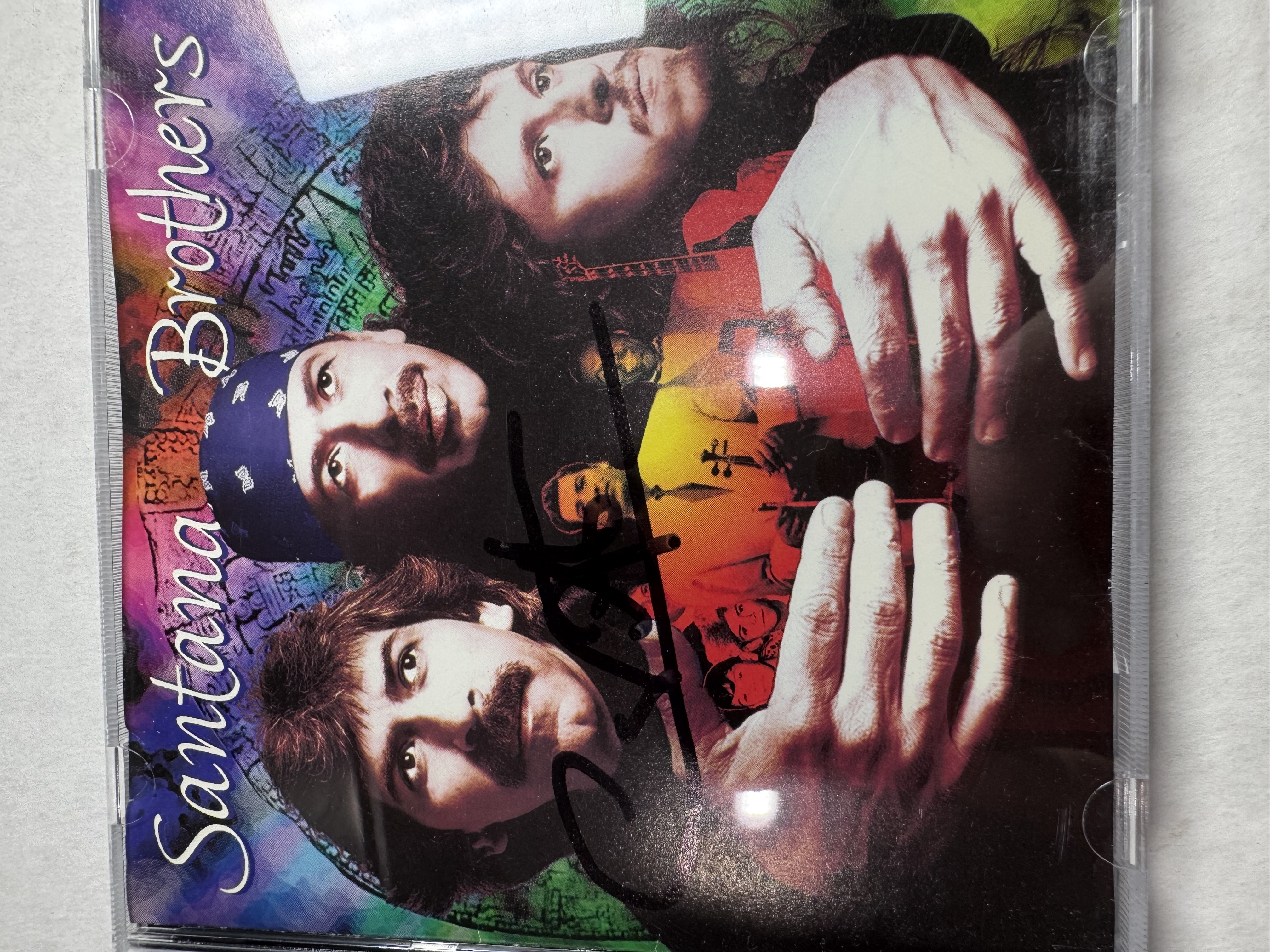 B112601 Santana Brothers CD signed by Carlos Santana