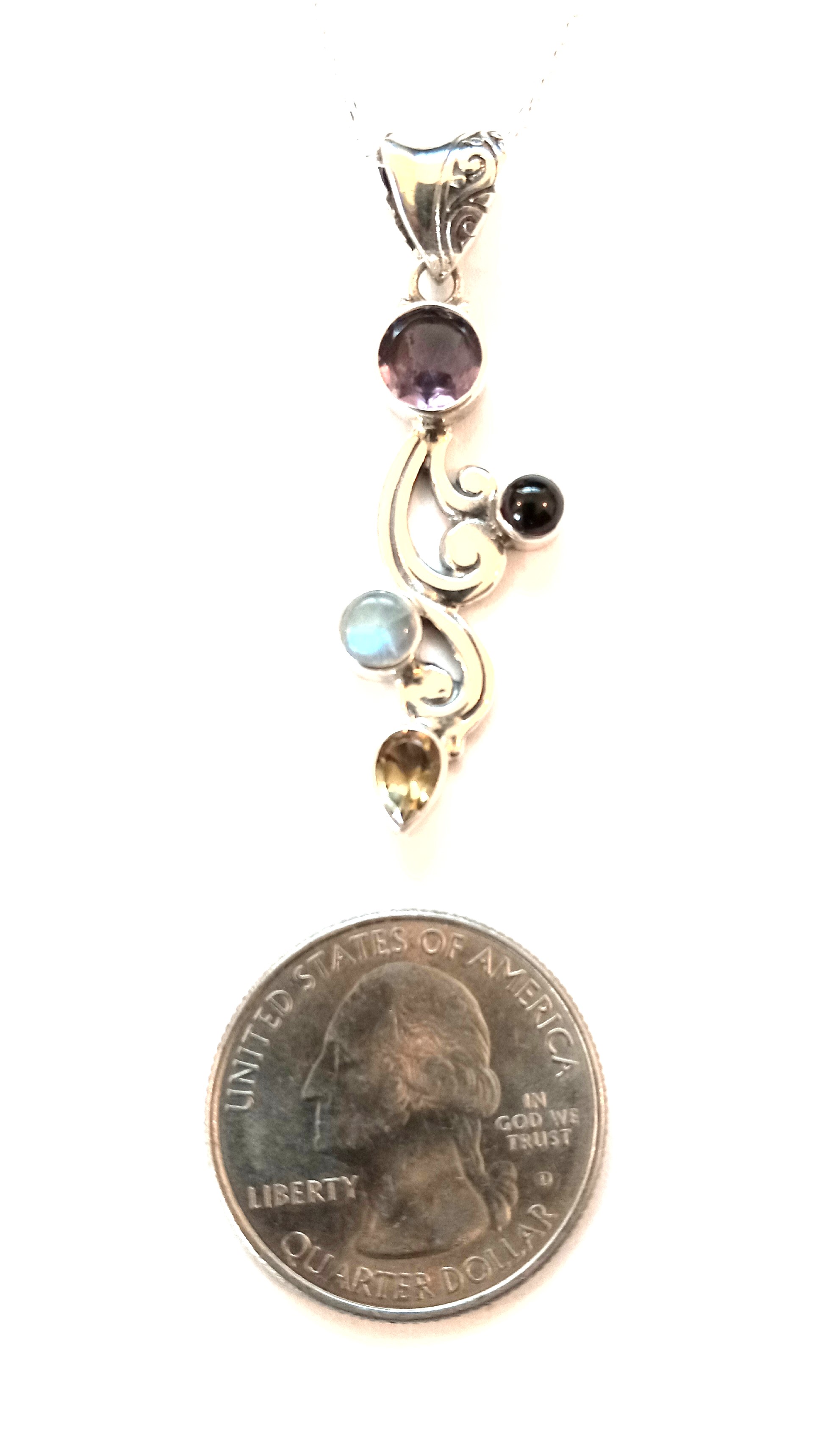 Pendant with multiple stones set in sterling silver.