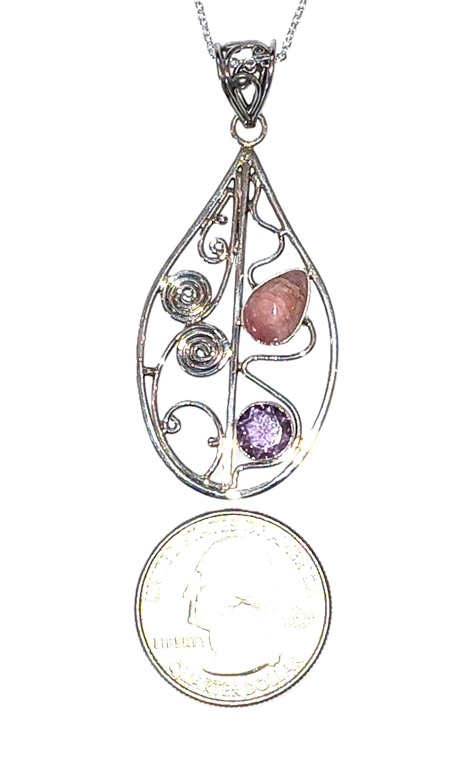 Rhodochrosite and Amethyst pendant set in sterling silver.