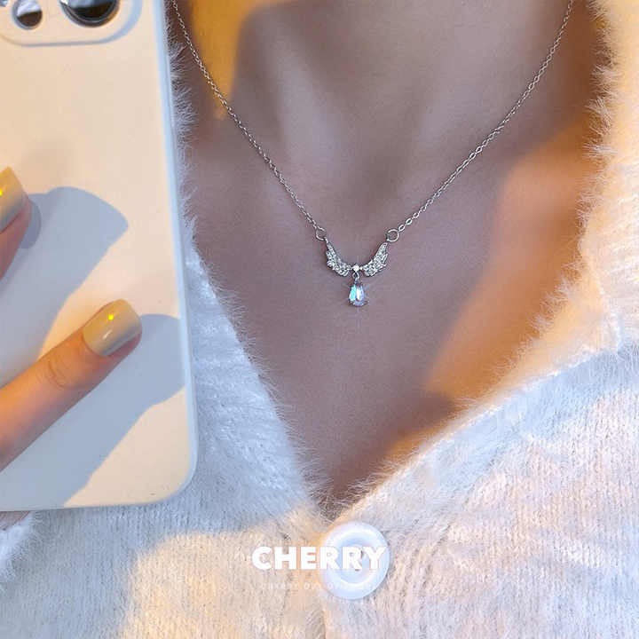 Shop elegant moonstone angel wings pendant necklaces — brass clavicle chain jewelry for women, perfect for daily wear, special occasions, and gifting.