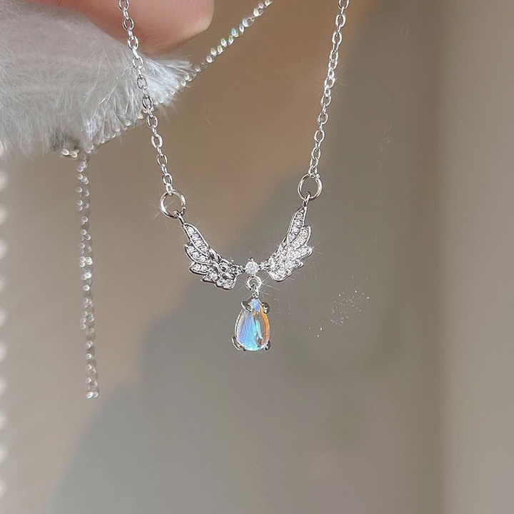 Shop elegant moonstone angel wings pendant necklaces — brass clavicle chain jewelry for women, perfect for daily wear, special occasions, and gifting.