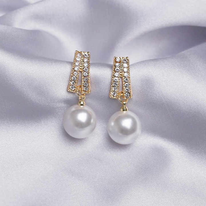 Elegant light ivory pearl drop earrings for weddings — platinum plated with sparkling cubic zirconia, perfect bridal jewelry for timeless beauty and grace.
