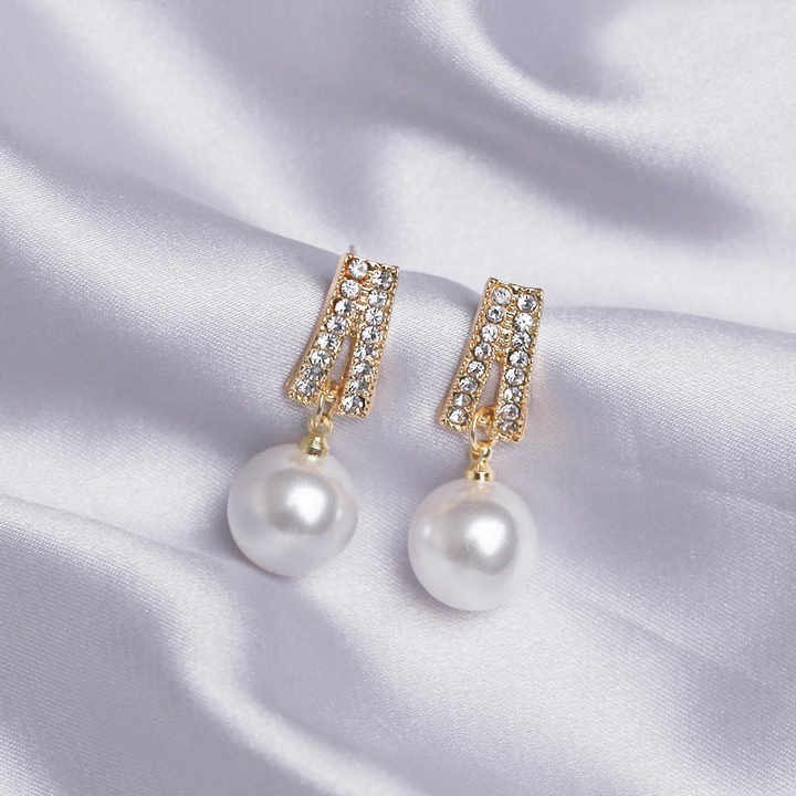 Elegant light ivory pearl drop earrings for weddings — platinum plated with sparkling cubic zirconia, perfect bridal jewelry for timeless beauty and grace.