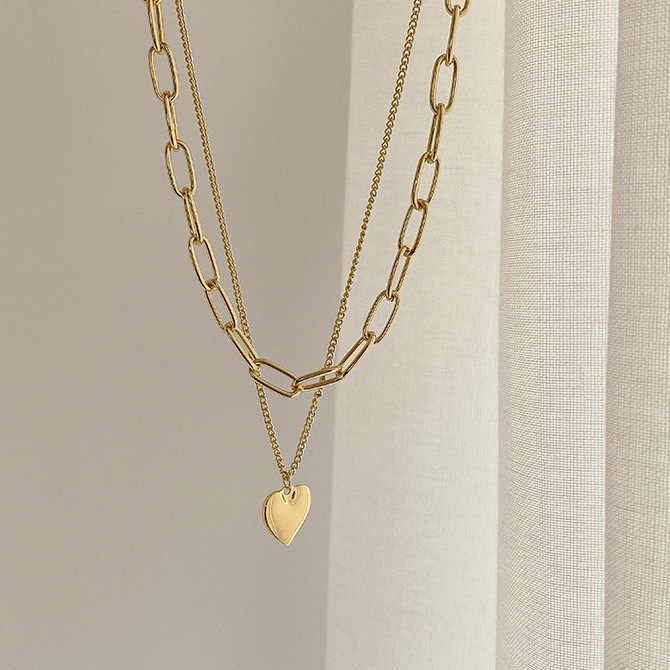 Chic multi-layer heart necklace with gold plating, featuring half pearl, half chain design — high-quality custom jewelry for women’s fashion and gifting.