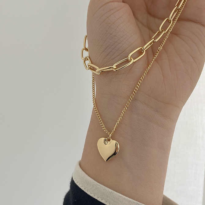 Chic multi-layer heart necklace with gold plating, featuring half pearl, half chain design — high-quality custom jewelry for women’s fashion and gifting.
