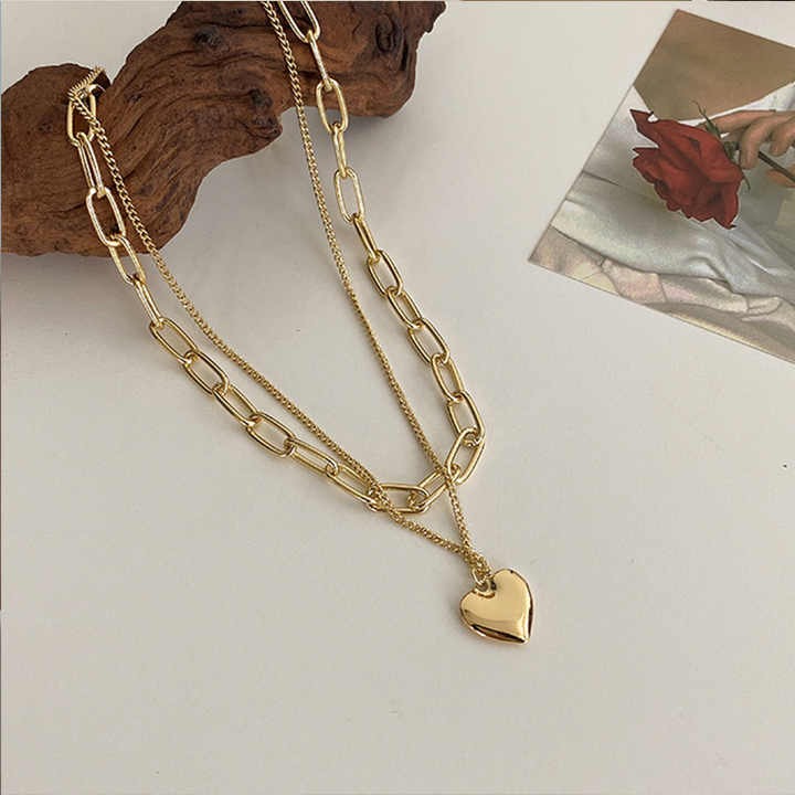 Chic multi-layer heart necklace with gold plating, featuring half pearl, half chain design — high-quality custom jewelry for women’s fashion and gifting.