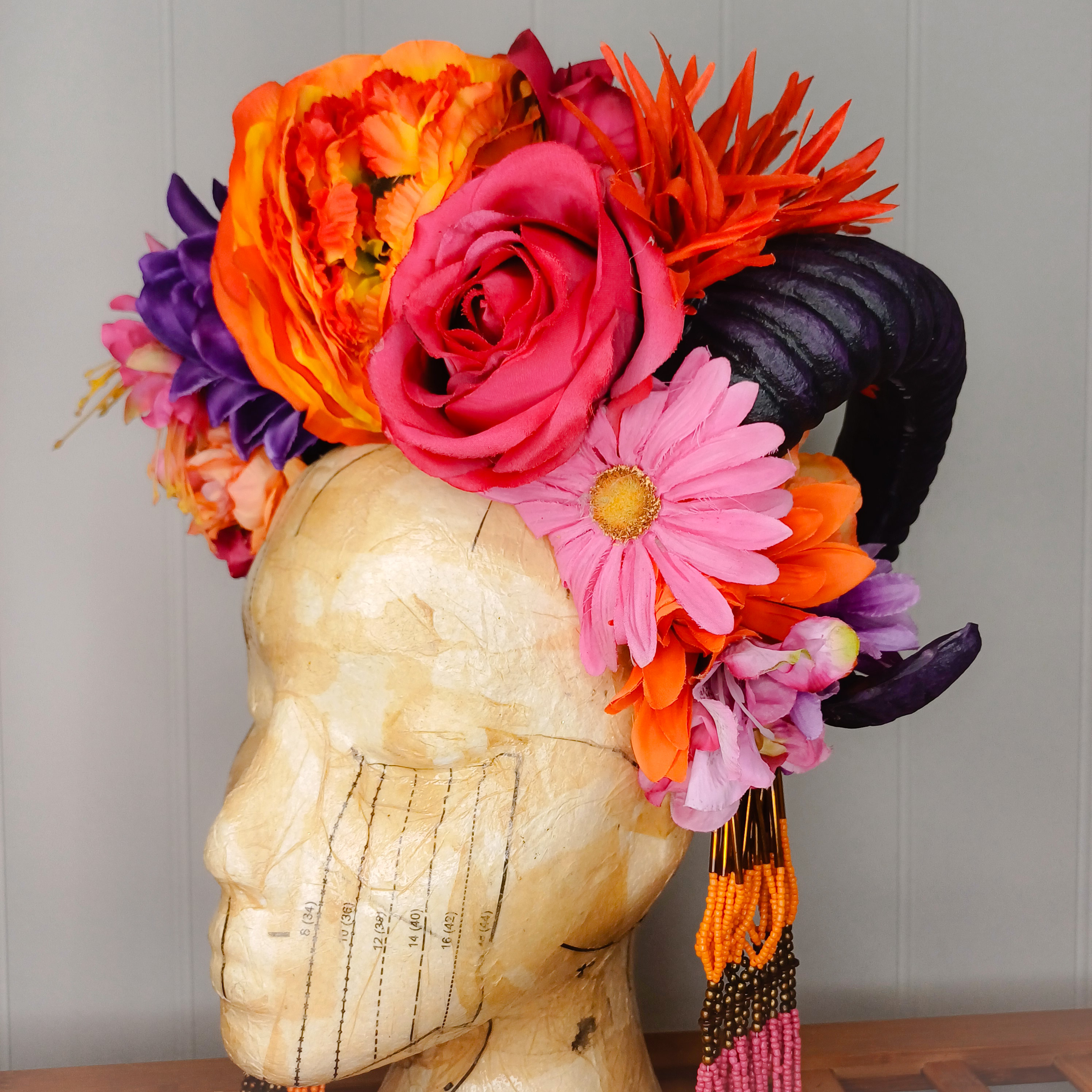 Floral headdress with horns and statement necklace