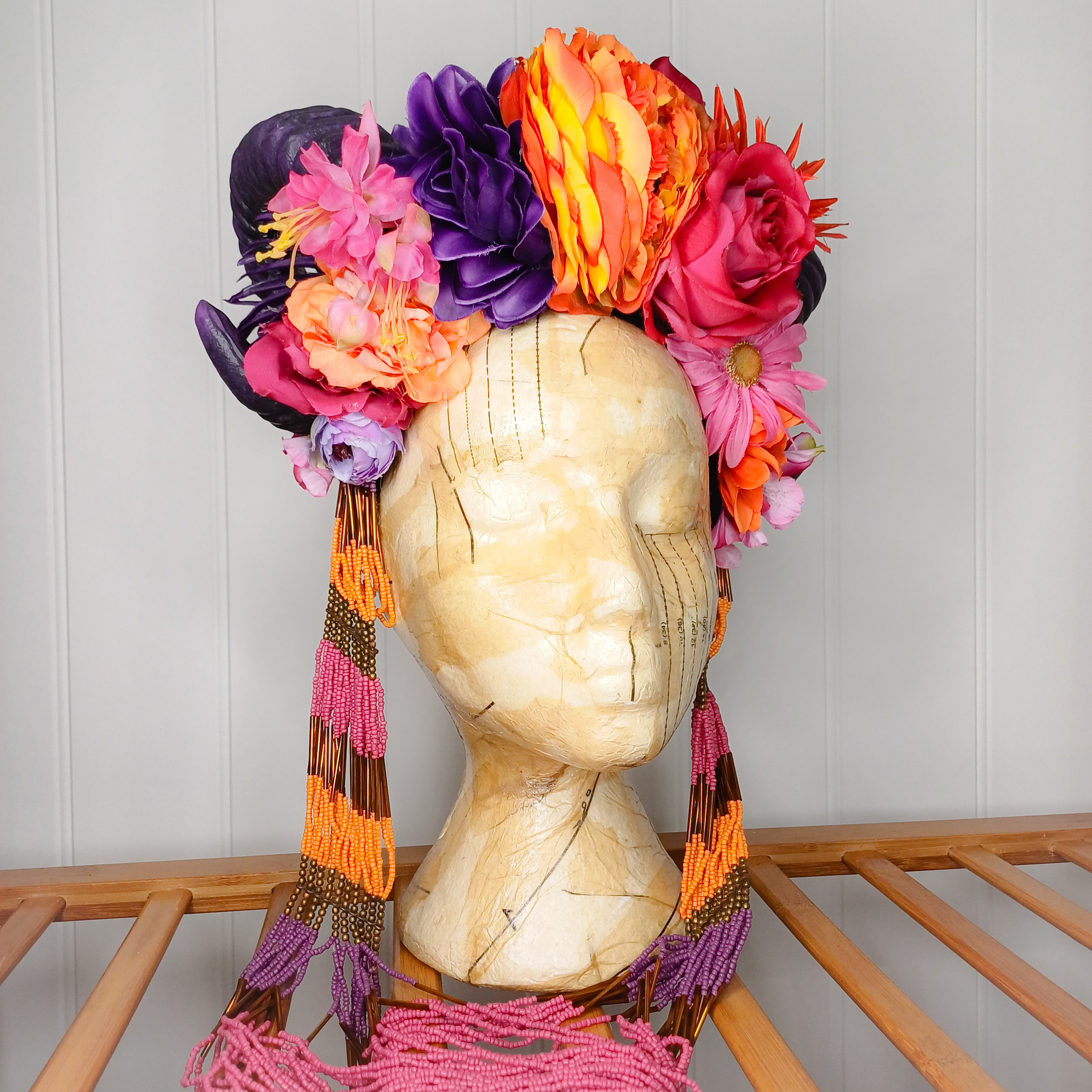 Floral headdress with horns and statement necklace