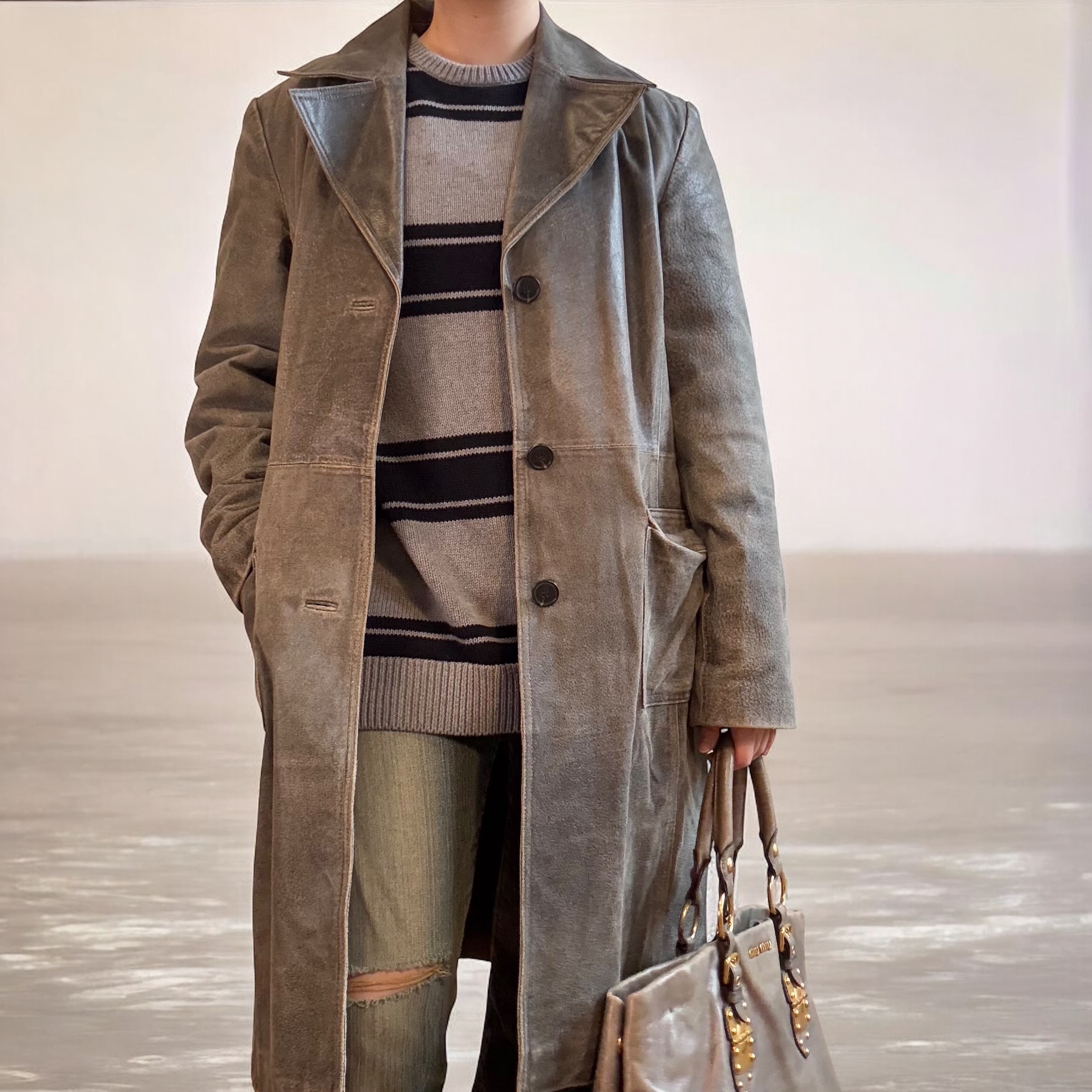 Distressed 100% leather trench coat.